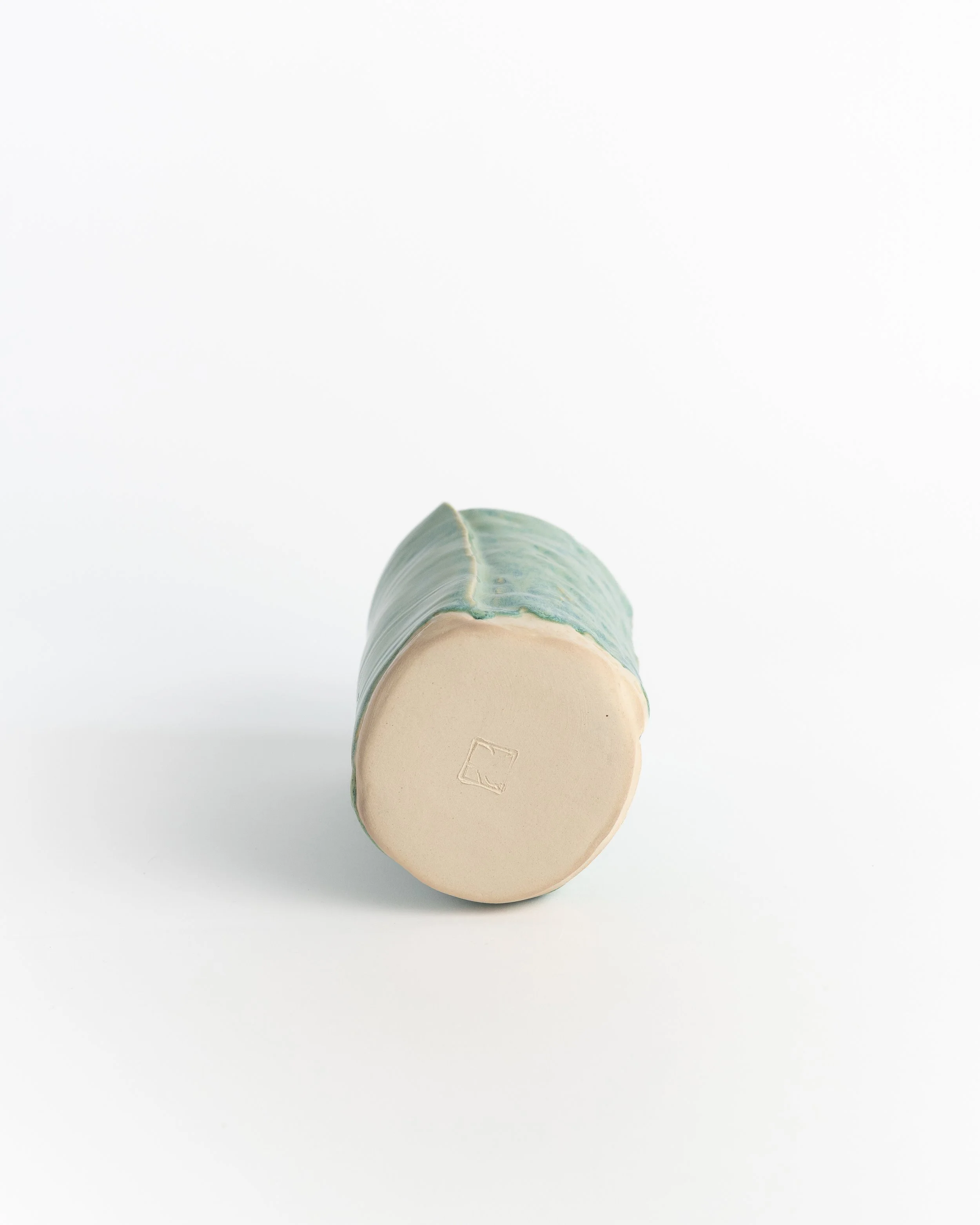 Underside of Faceted Green showing the unglazed foot and maker's mark.