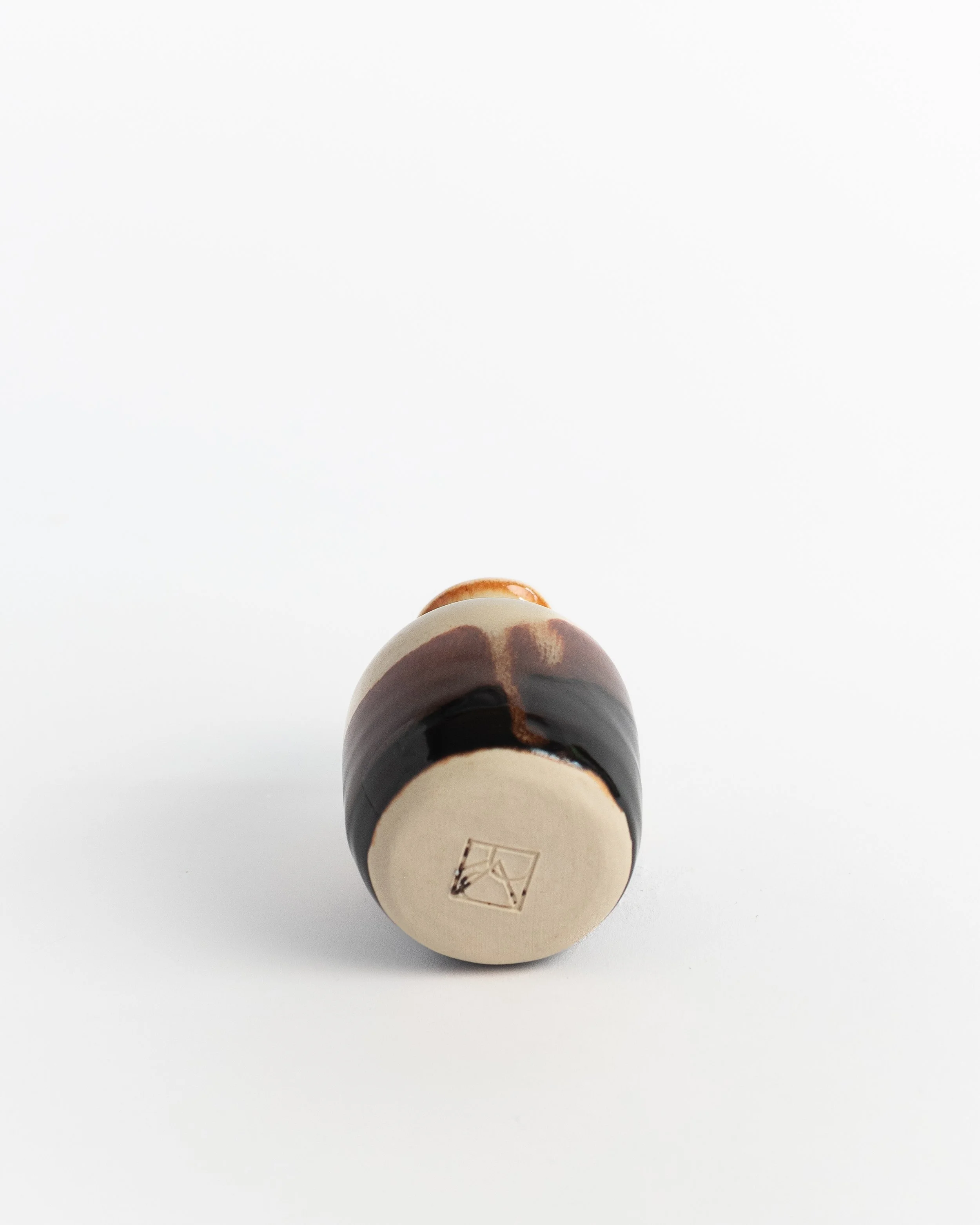Underside of Ember Bud Vase showing the unglazed foot and maker's mark.