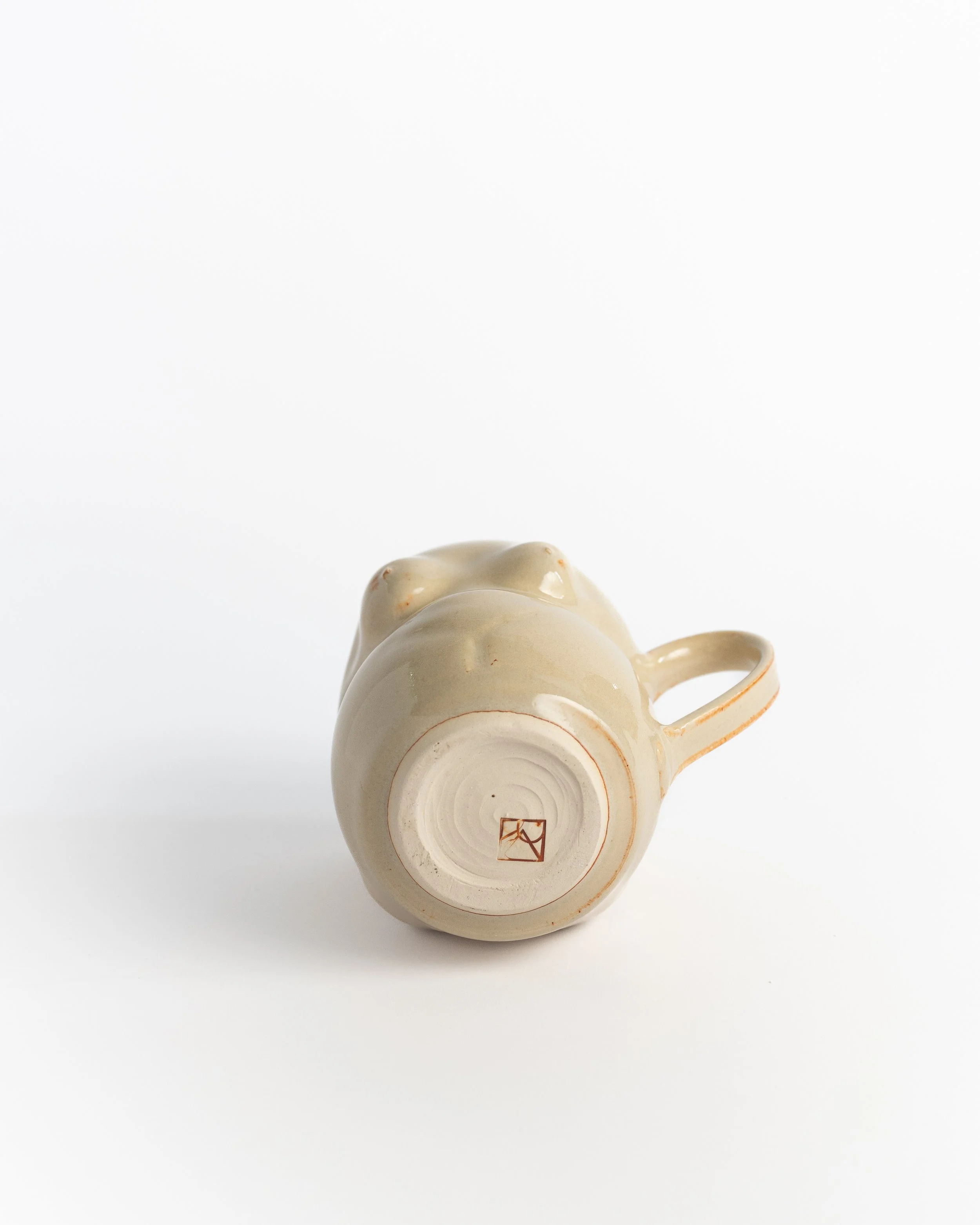 Underside of Figure Mug showing the unglazed foot and maker's mark.