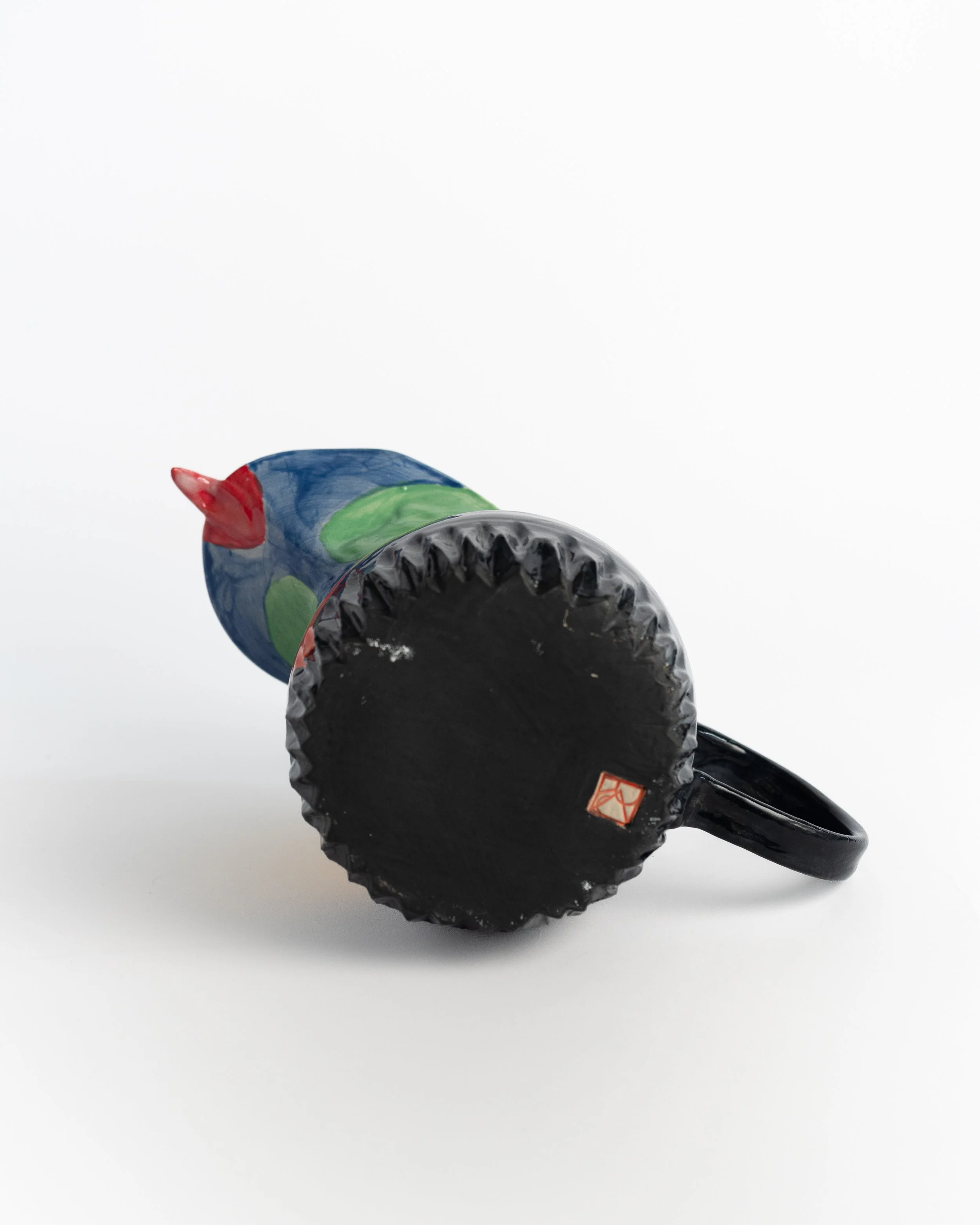 Underside of Toucan Pitcher showing the unglazed foot and maker's mark.