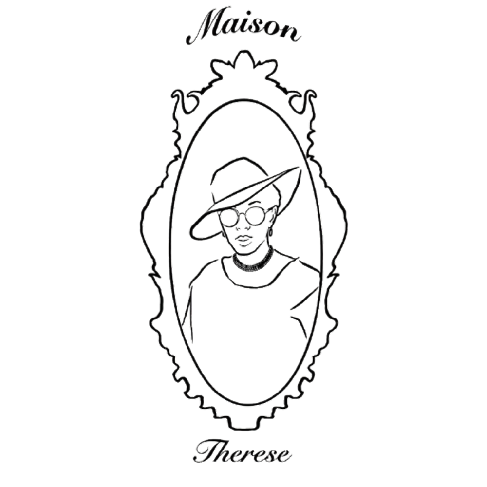 A neon outline of a woman with short hair wearing sunglasses and a wide-brimmed hat, framed by an ornate mirror outline. The words "Maison" are written above and "Therese" below the mirror.