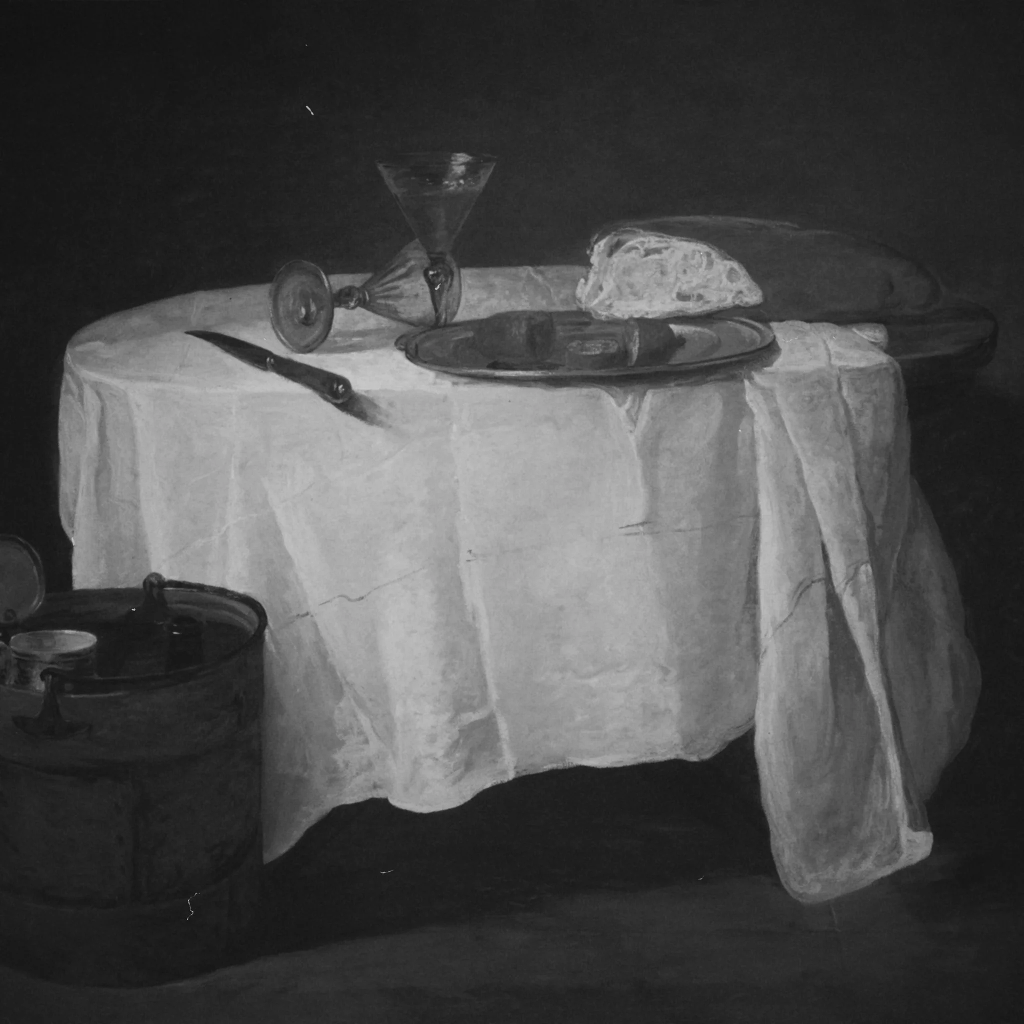 A black and white still life painting of a table covered with a cloth, with a loaf of bread, knives, a plate, wine glasses, and a bucket in the scene.