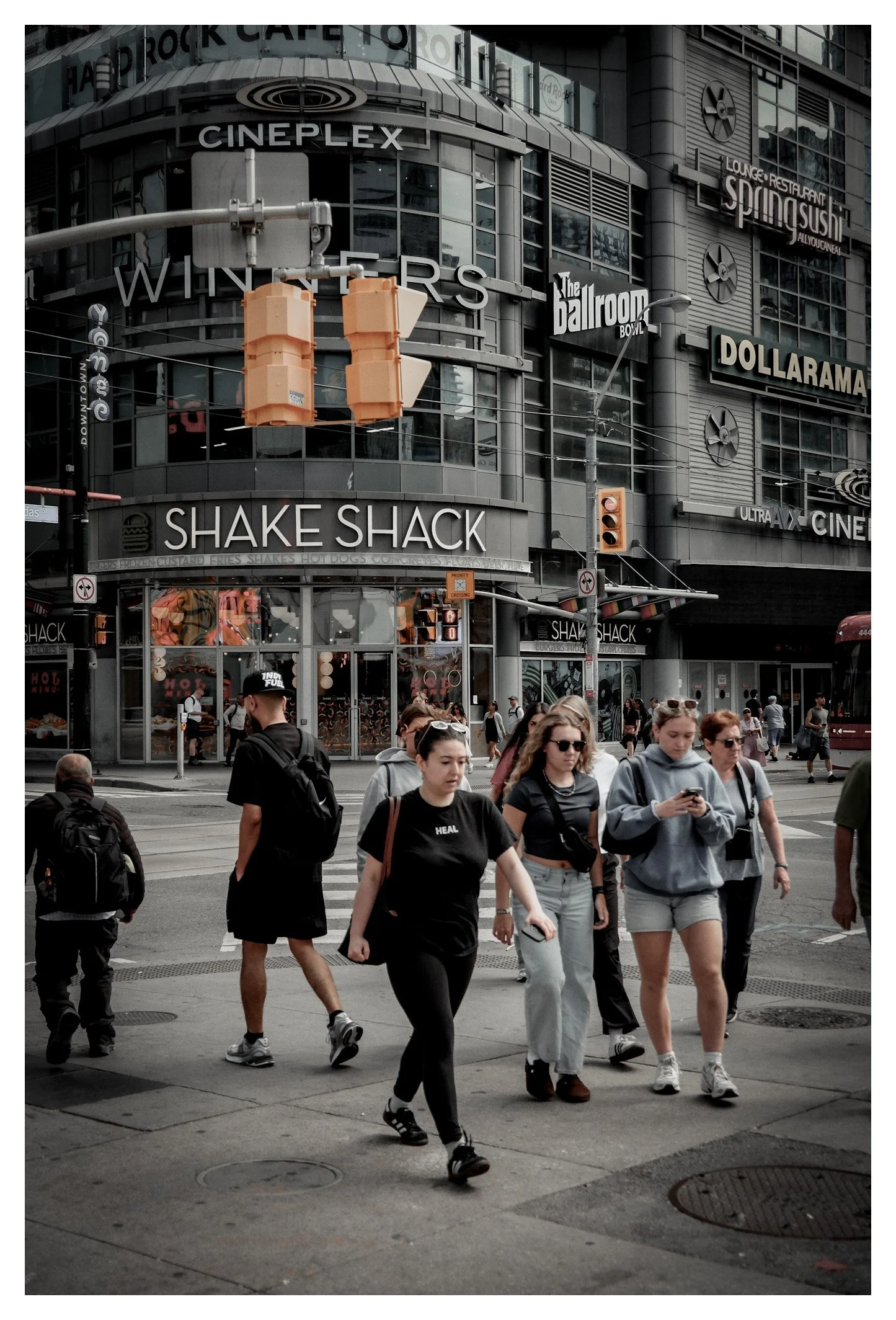 In the heart of downtown, global brands and everyday life blend into one vibrant urban scene. Every passerby becomes part of the city's ever-changing rhythm.
