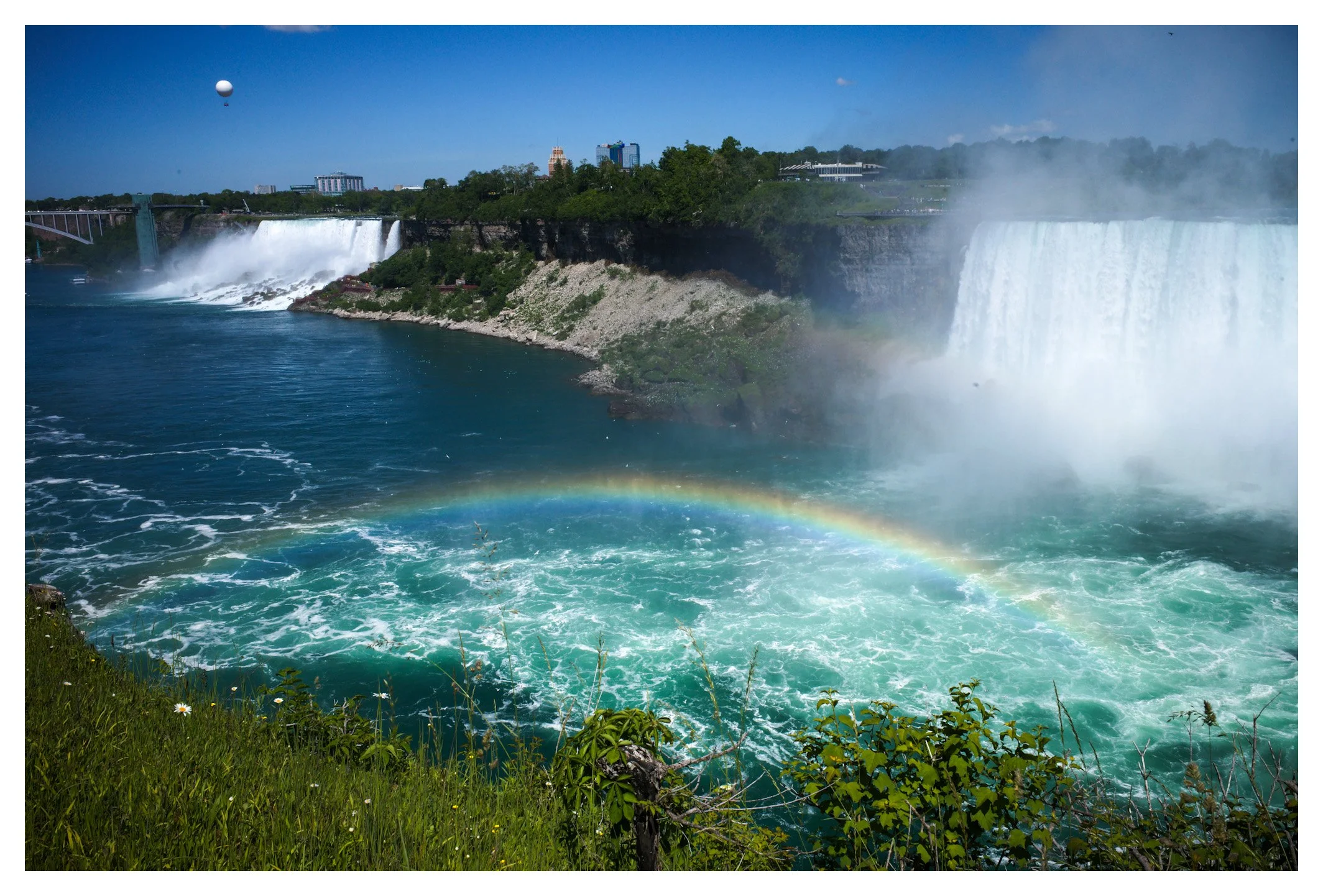 Mist, sunlight, and millions of liters of water combine to create one of nature's most breathtaking spectacles. The fleeting rainbow adds the perfect finishing touch to an already unforgettable landscape.