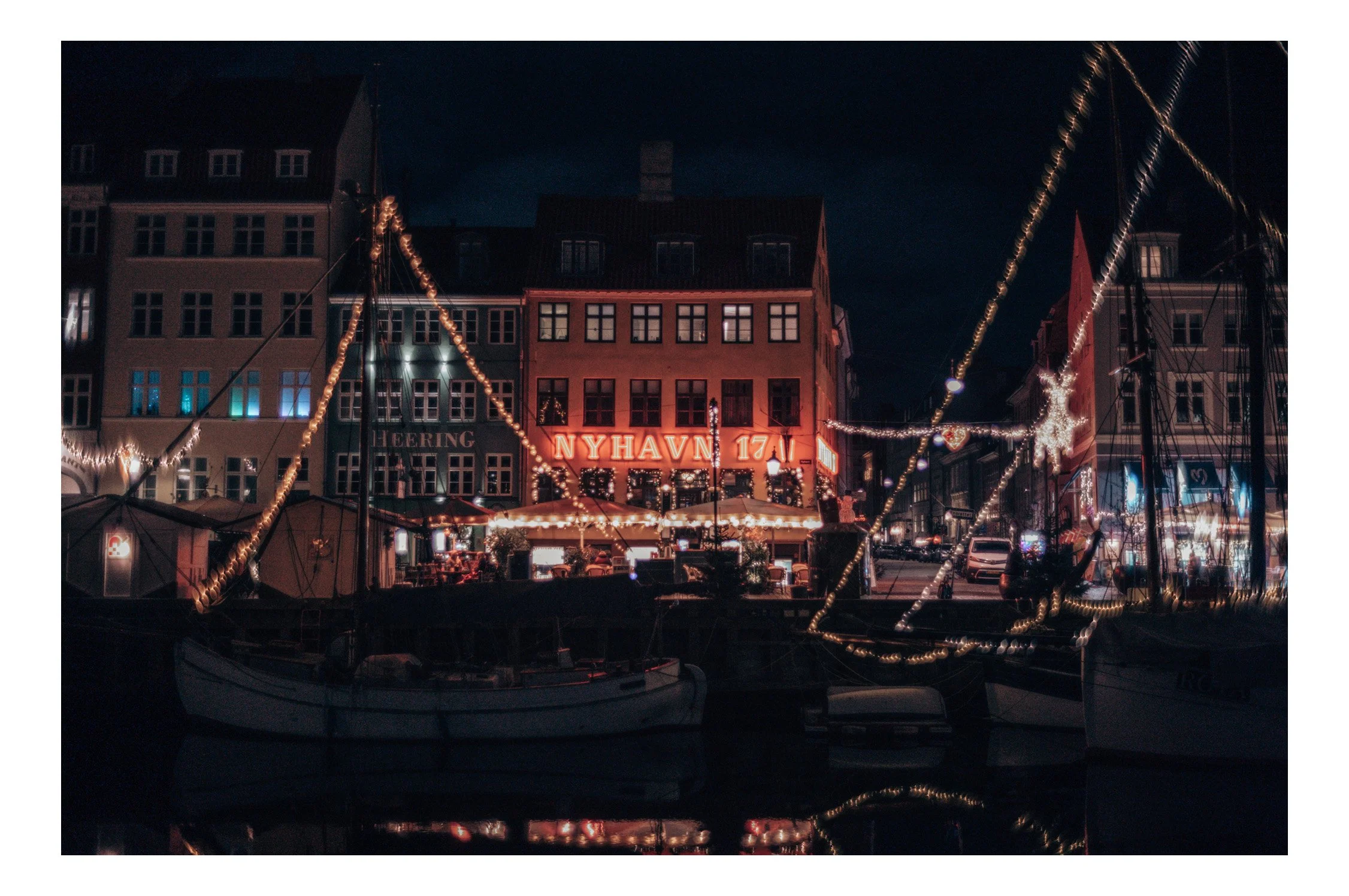 Nyhavn at night feels calm and magical. The colorful houses glow in the reflections of the water, while the restaurants light up with warm candles and soft music. You can walk along the harbor and feel the city slow down — peaceful, romantic, and bea