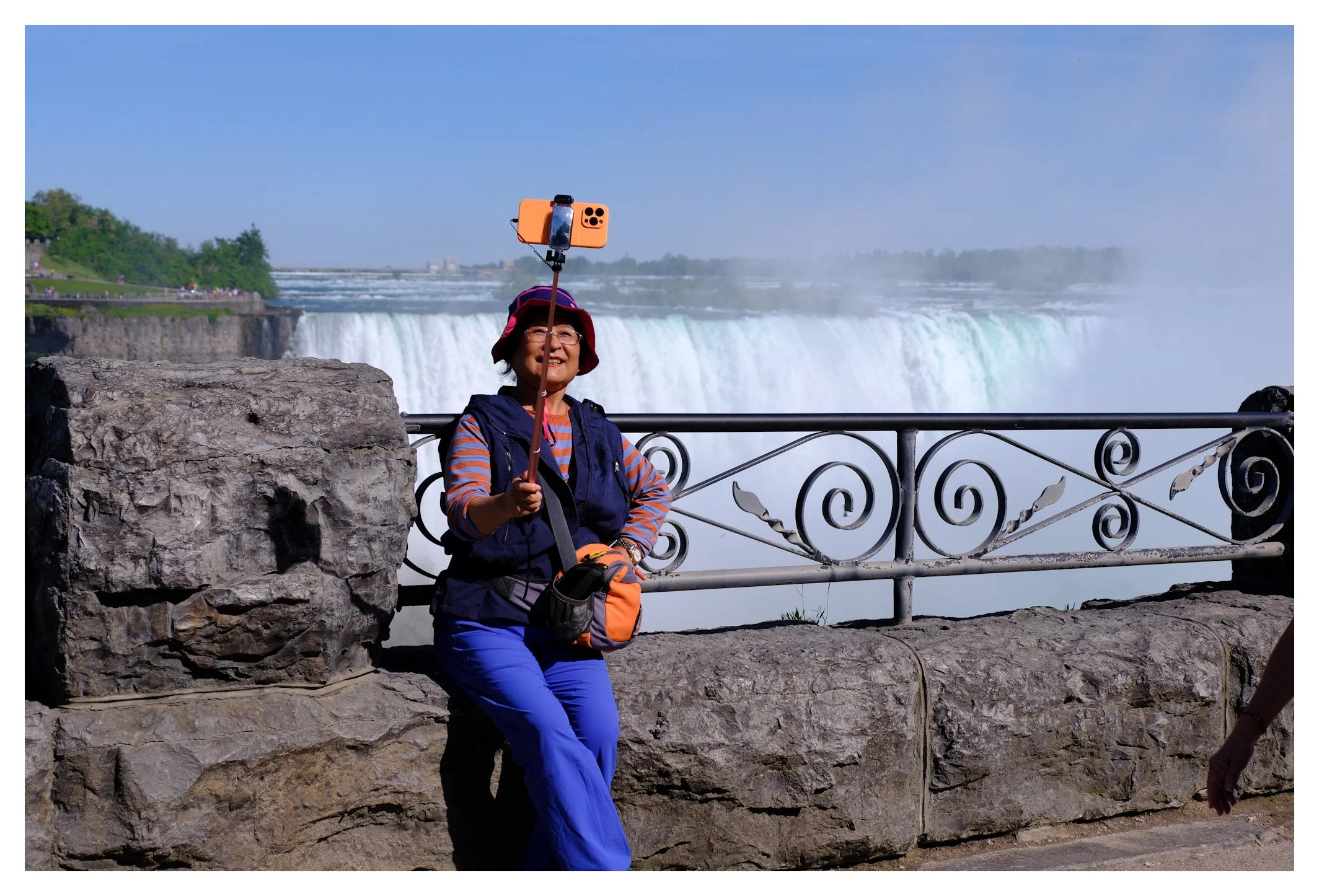 A selfie stick, a bright smile, and the thunder of Niagara Falls in the background. Modern travel is just as much about sharing the moment as it is about experiencing it.