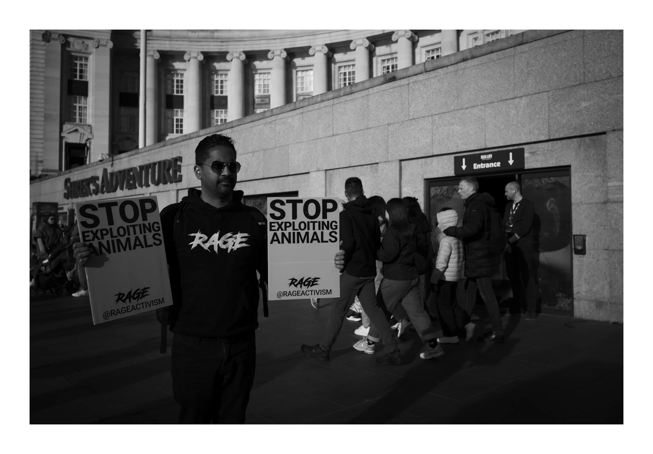 A man protesting against animal extinction—his message echoing through the streets, capturing a moment of conviction and urgency.