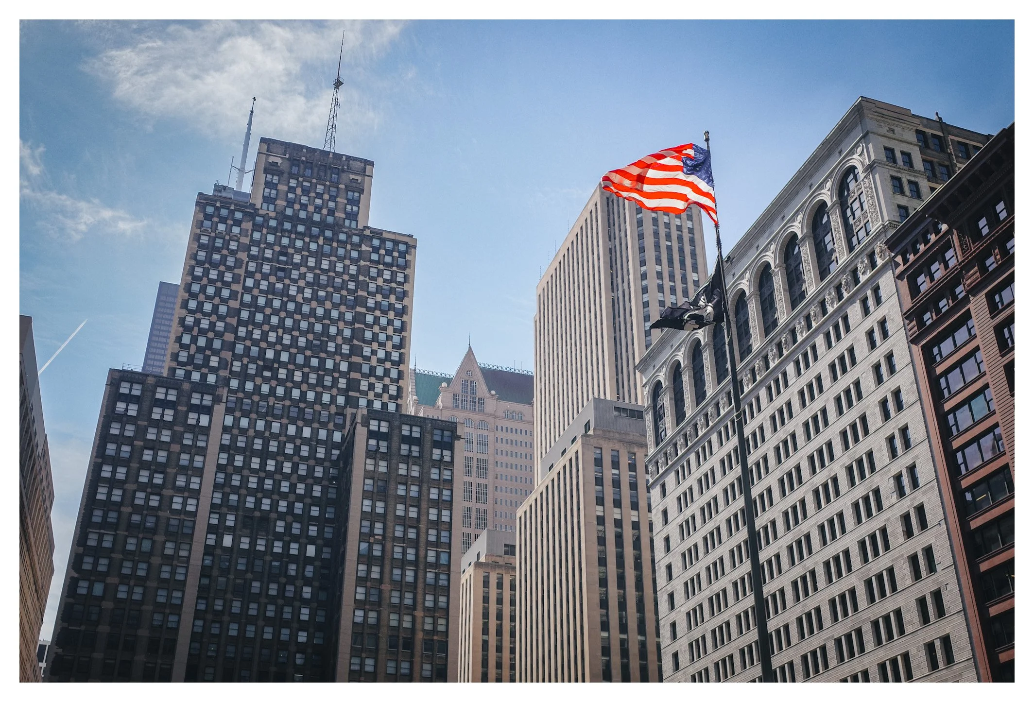 Surrounded by towering architecture, the Stars and Stripes stand tall in the heart of Chicago. A timeless symbol against the city's ever-changing skyline.