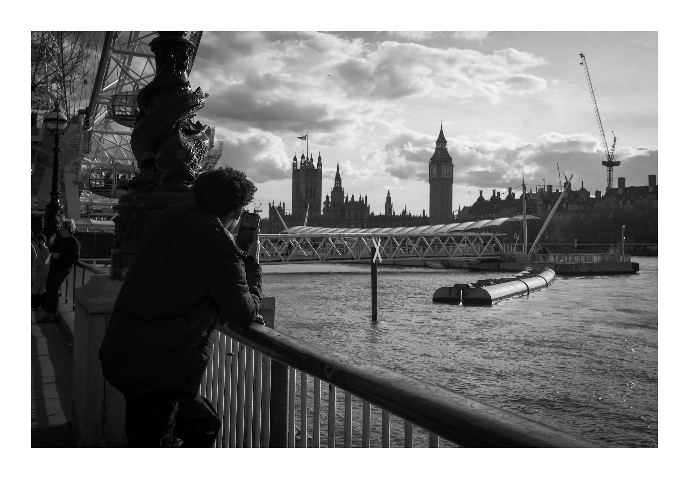 A man stands by the Thames, gazing at Big Ben—a quiet moment of reflection framed by one of London’s most iconic landmarks.
