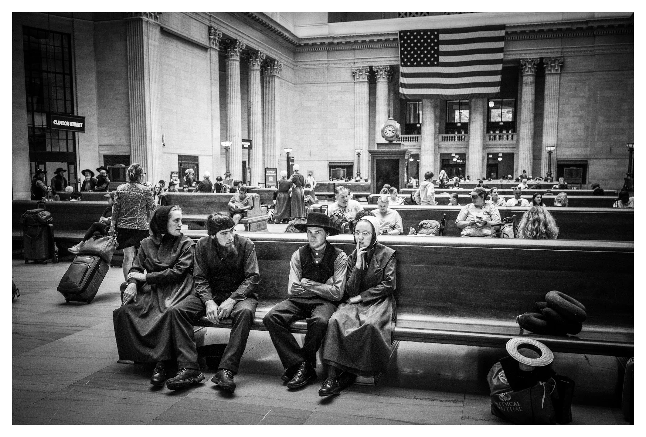 Beneath the grand architecture of Union Station, travelers from every walk of life share the same waiting hall. A timeless scene in one of Chicago's most iconic landmarks.

