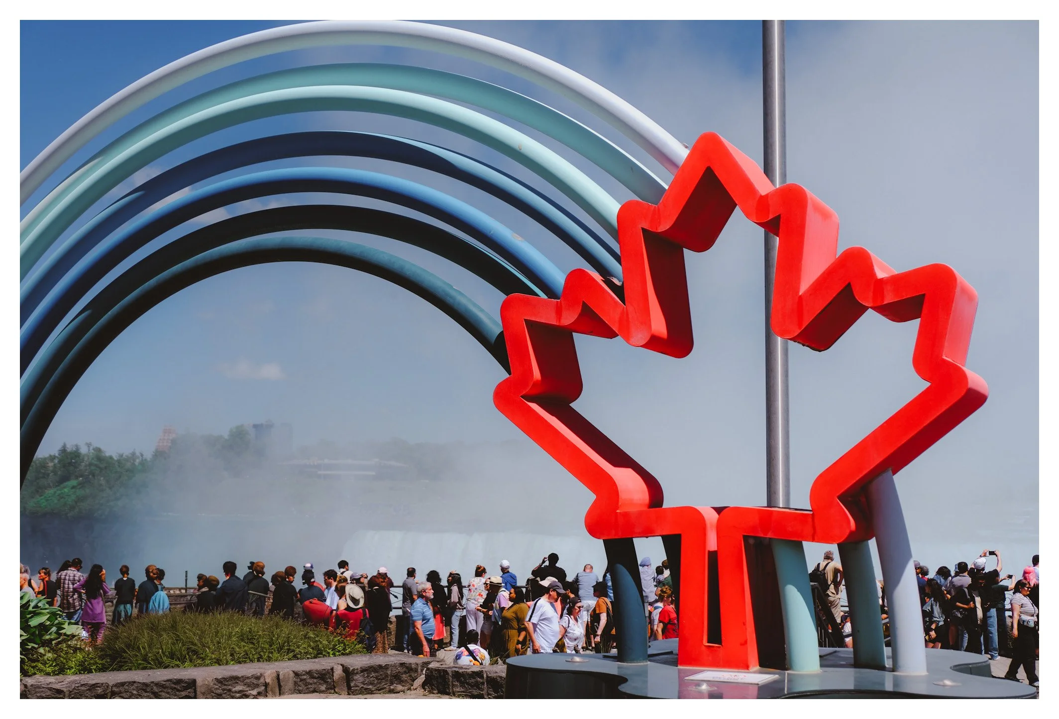 The iconic maple leaf sculpture welcomes visitors to one of Canada's most breathtaking natural wonders. A vibrant symbol framed by the endless power of Niagara Falls.