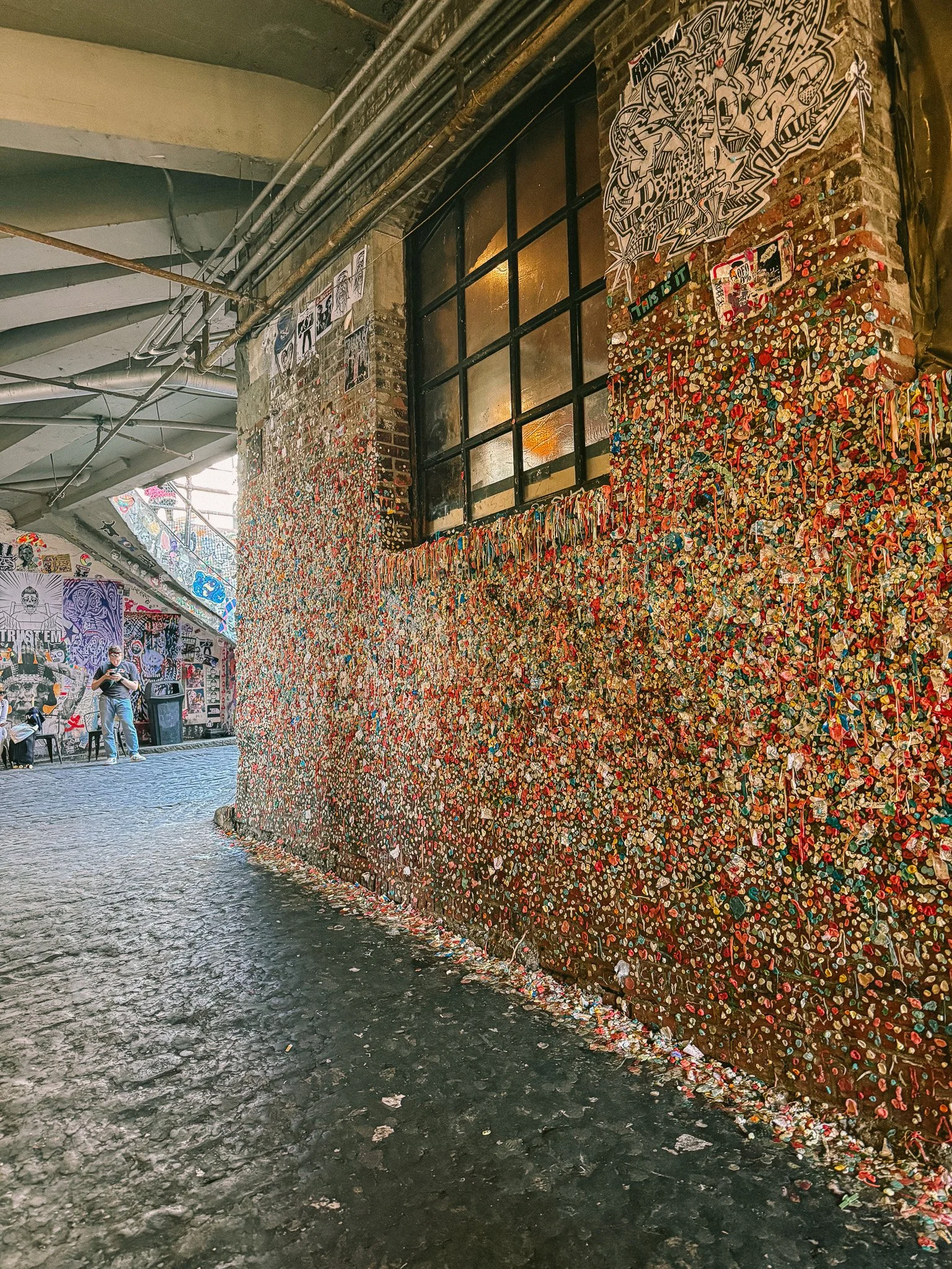 The Gum Wall is one of Seattle’s most unusual and iconic street attractions.
Covered with thousands of pieces of colorful chewing gum, it has evolved into an unexpected form of public art.