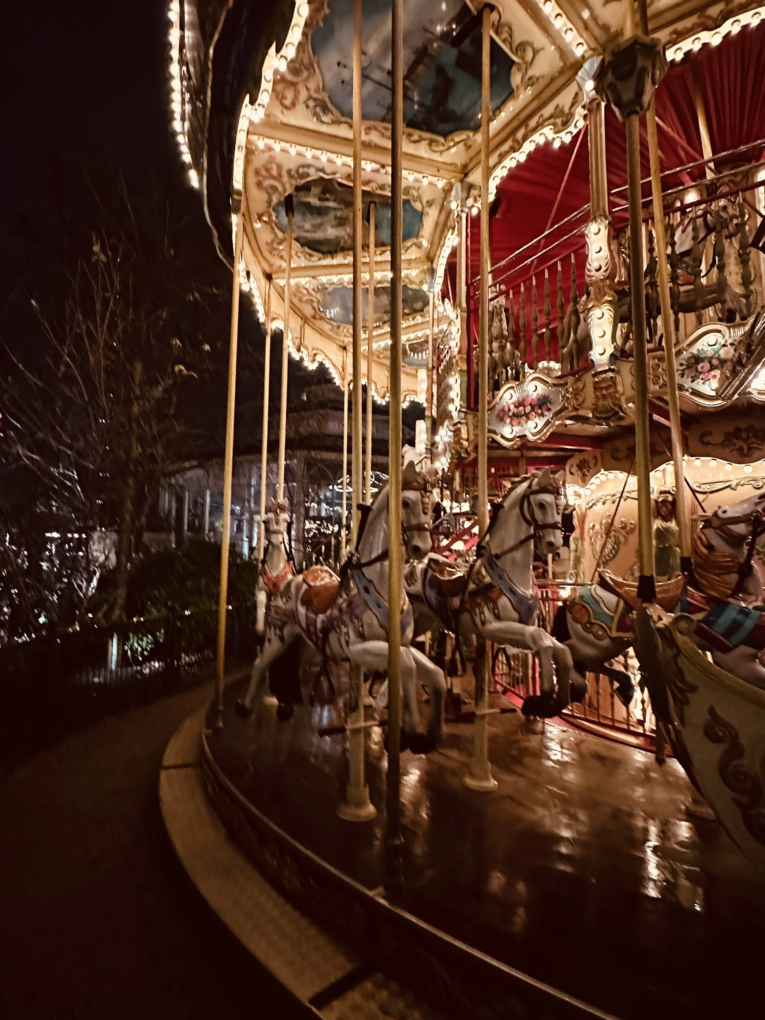 The old carousel in Tivoli Gardens spins slowly under a canopy of lights, full of nostalgia and charm. The wooden horses, painted in soft colors, feel like they’ve carried generations of visitors. It’s whimsical, romantic, and one of those timeless m