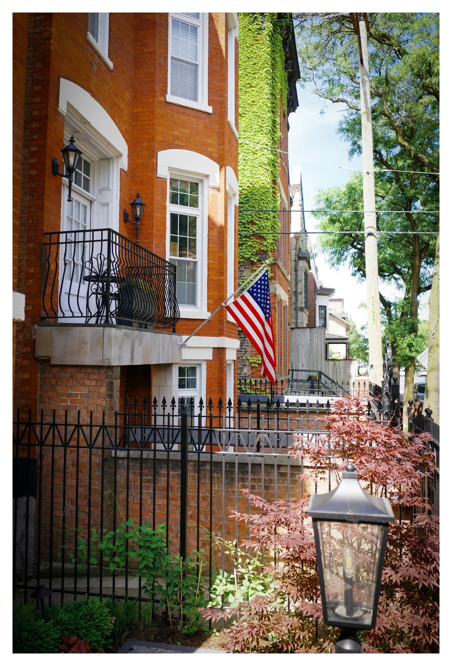 Historic brick homes, lush greenery, and the American flag create a scene full of warmth and character. A reminder that Chicago's beauty extends far beyond its downtown skyline.