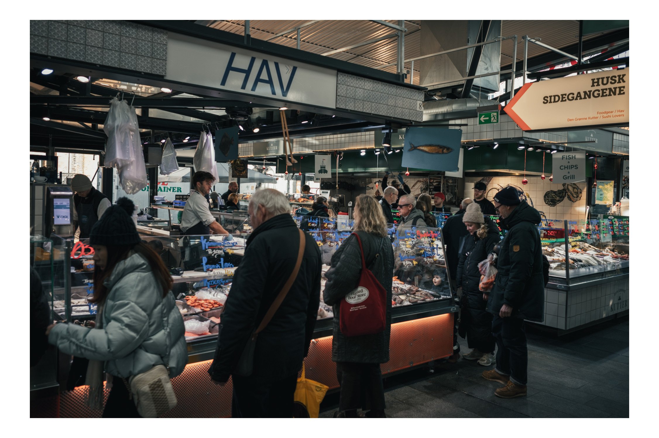Torvehallerne is Copenhagen’s most famous food market — two bright glass halls filled with gourmet stalls, fresh seafood, pastries, cheeses, coffee, and Nordic specialties. You can grab small plates from different vendors, sit down with a glass of ch