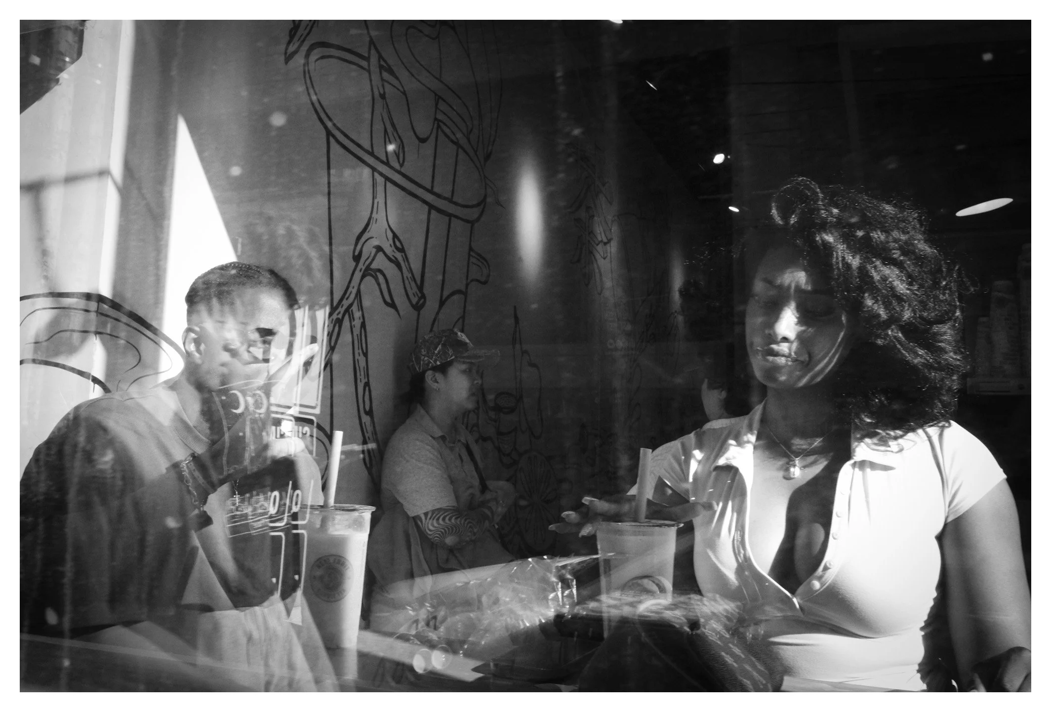 Street photography isn't always about the streets. Through reflections, light, and quiet expressions, ordinary moments become layered stories waiting to be discovered.