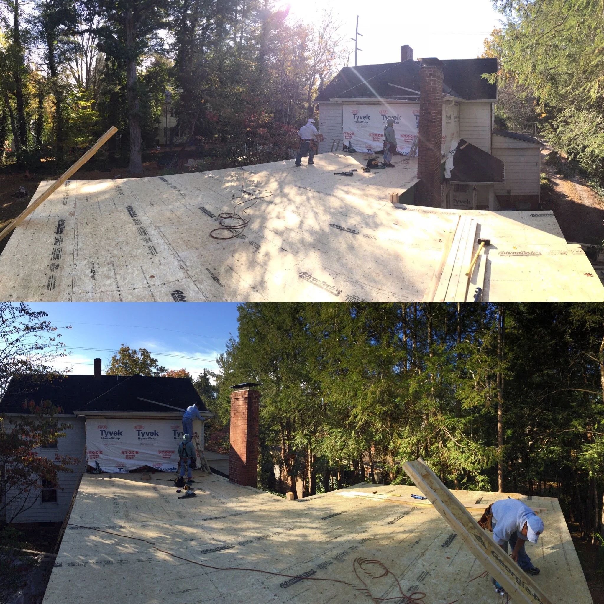 Construction workers installing a new roof on a residential house during daylight, with trees in the background.