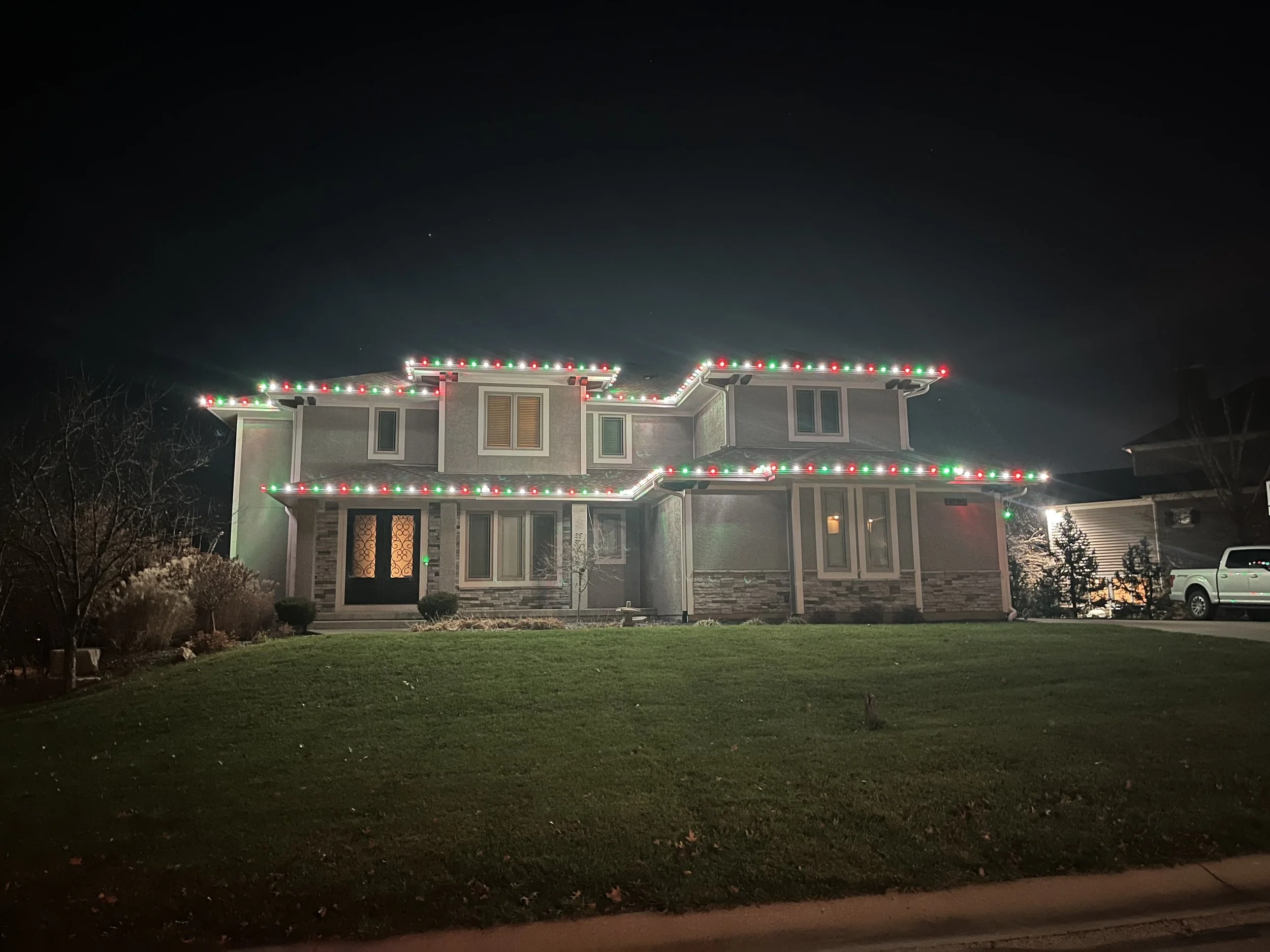 Christmas light installation on Olathe KS home with red and warm white C9 LED bulbs