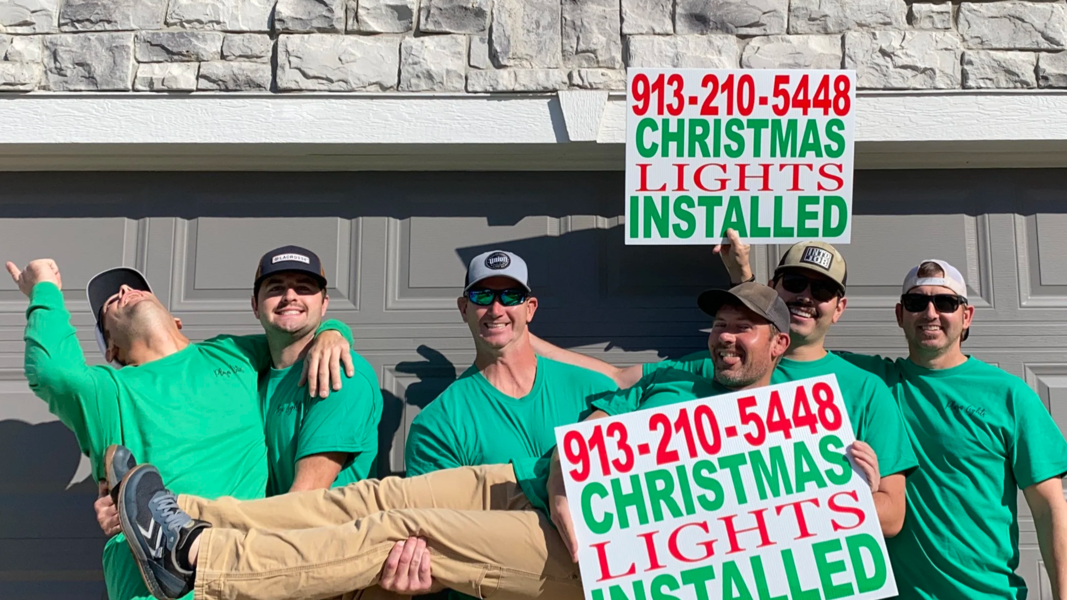 Guys taking fun picture with signs and hats