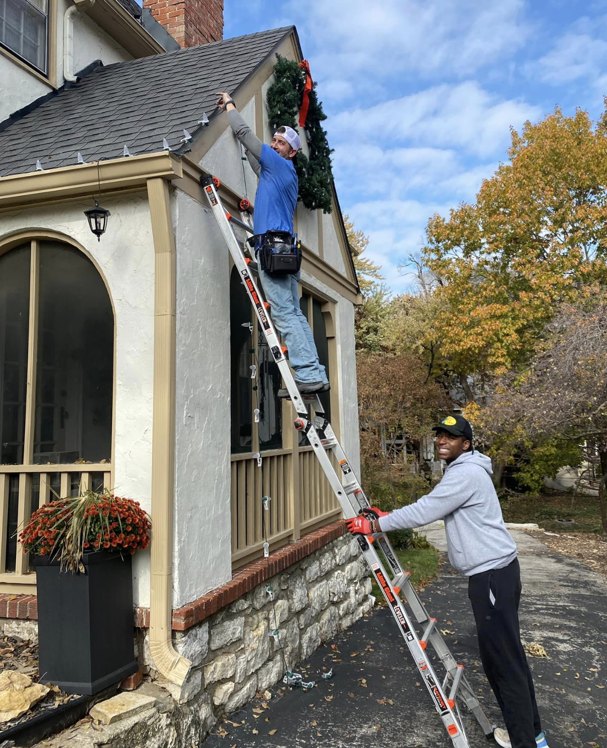 Hanging a wreath on house safely with ladder