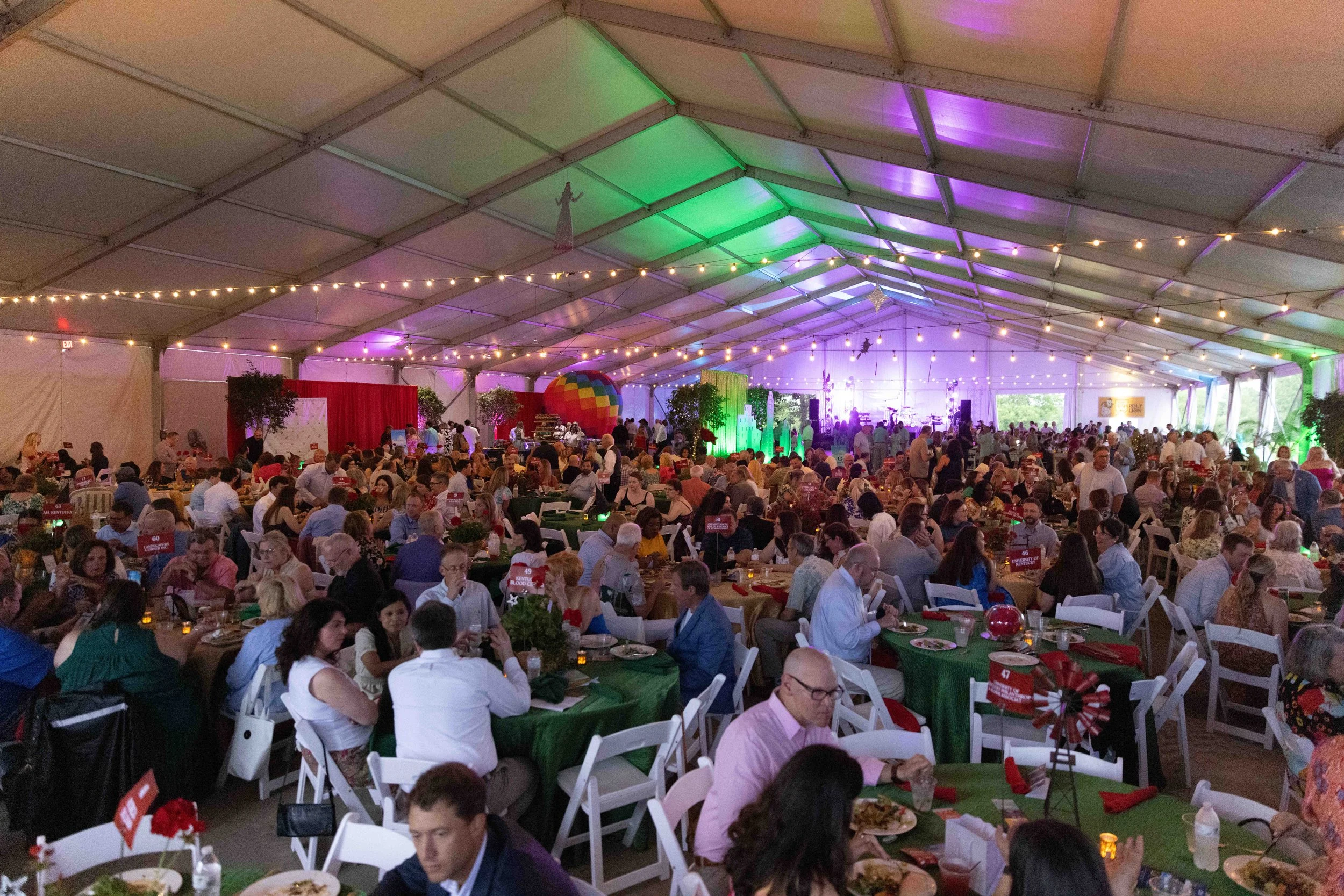 Grand-scale indoor gala and banquet coverage featuring a decorated tent and colorful event lighting in Lexington, KY, by 859 Photography.
