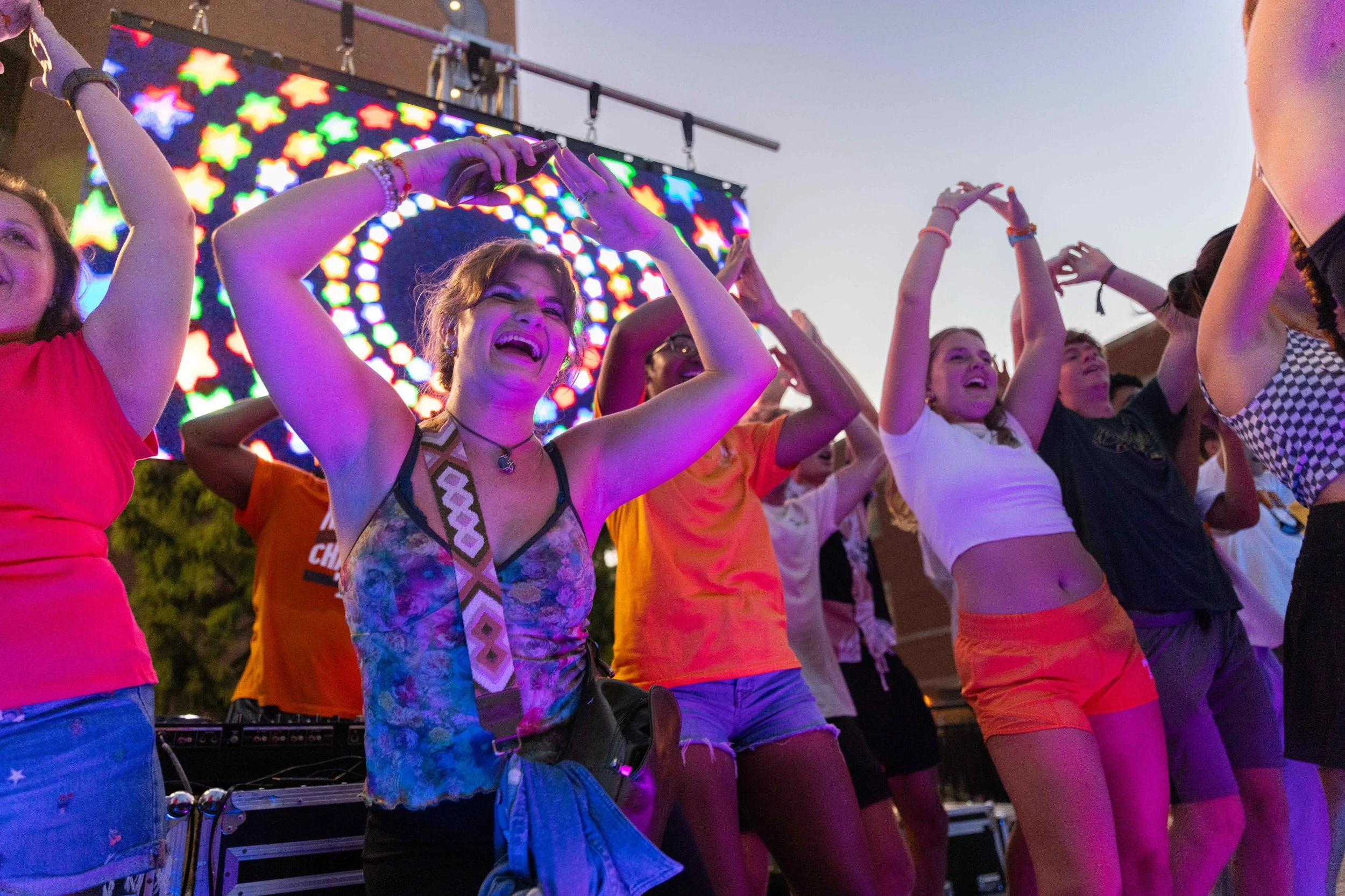 Crowd dancing at an outdoor sunset concert in Lexington, KY, featuring vibrant LED stage lighting and event atmosphere photography by 859 Photography.