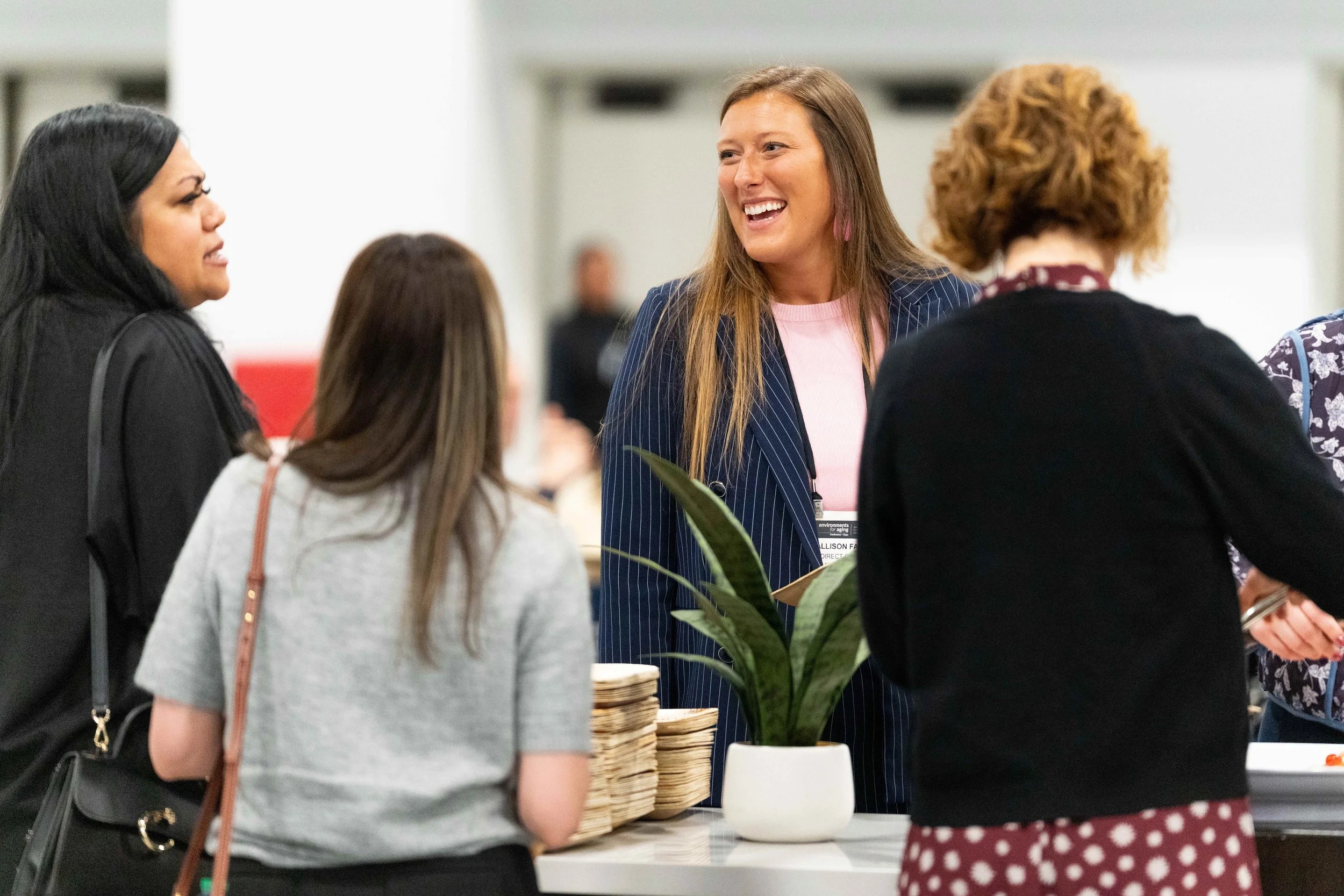 Candid networking session at the Central Bank Center in Lexington, KY, featuring a group of professional women at a conference, photographed by 859 Photography.