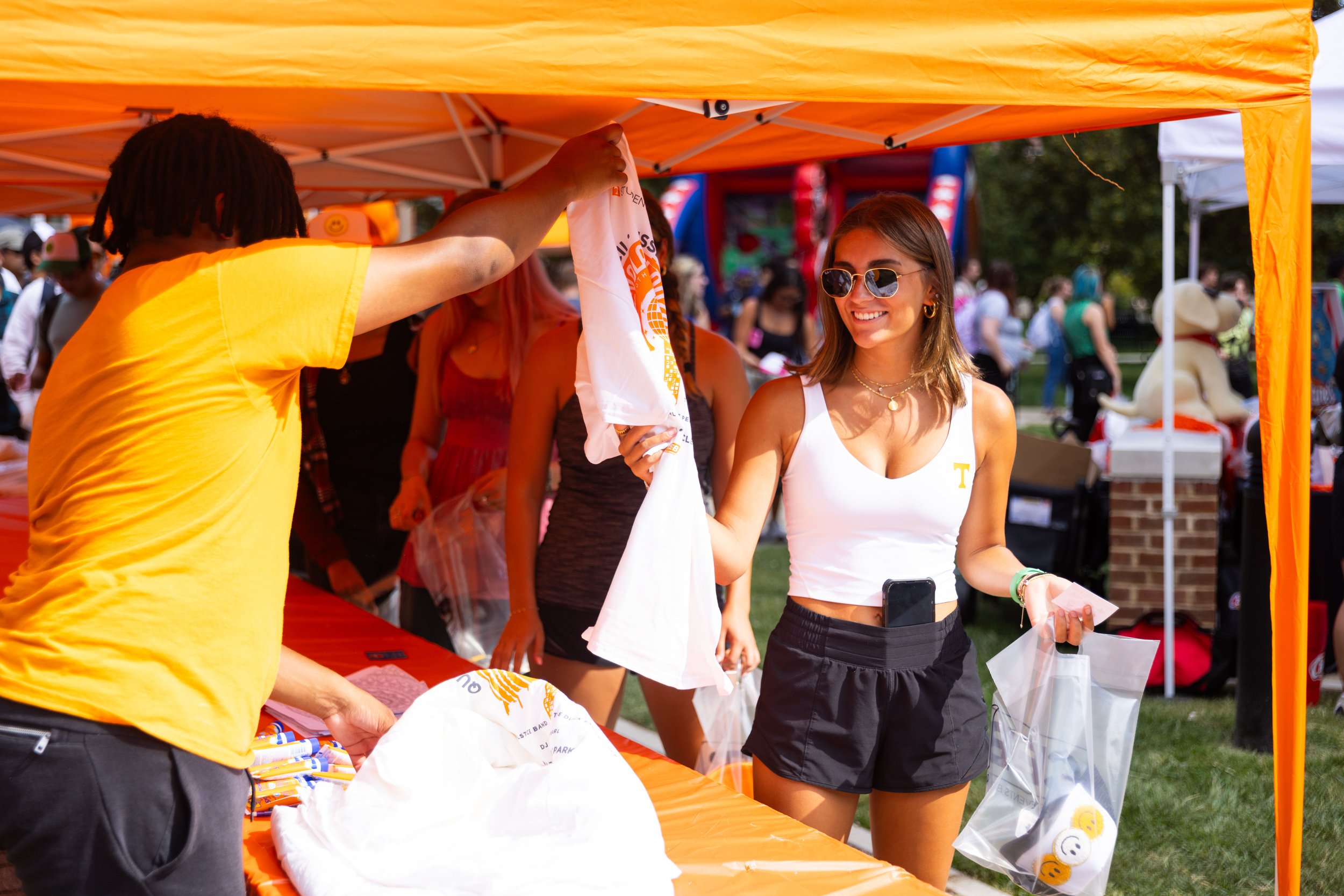 Event attendee receiving promotional merchandise at an outdoor brand activation booth in Lexington, KY, captured by 859 Photography.