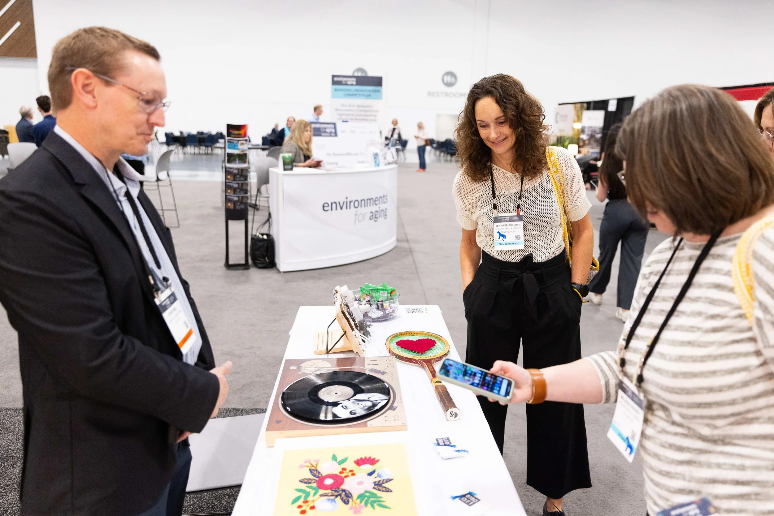 Trade show attendees viewing a creative art and vinyl record exhibit at the Central Bank Center in Lexington, KY, captured by 859 Photography.