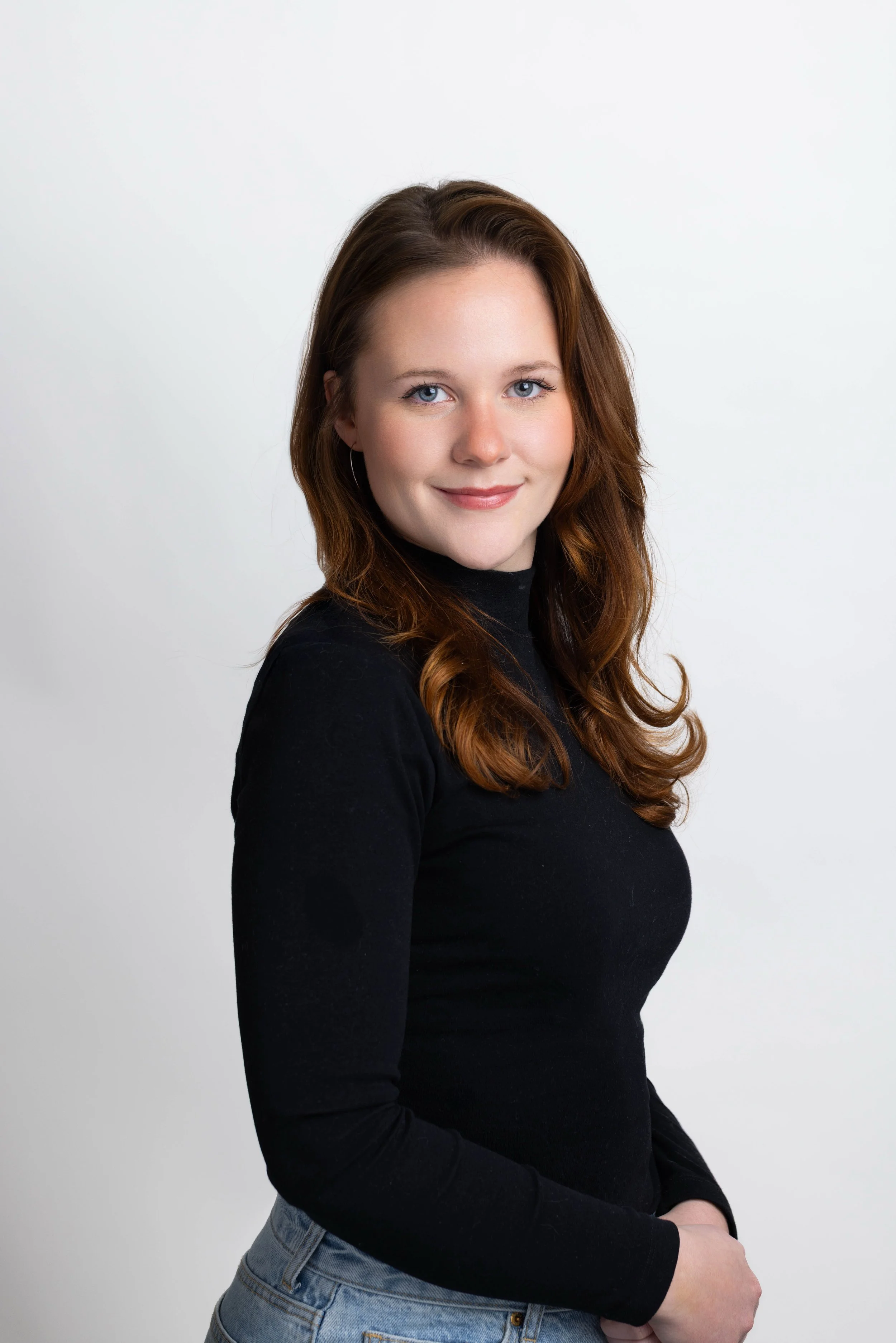 Professional studio headshot of a woman in a black turtleneck, captured by 859 Photography at a mobile on-site portrait station in Lexington, KY.