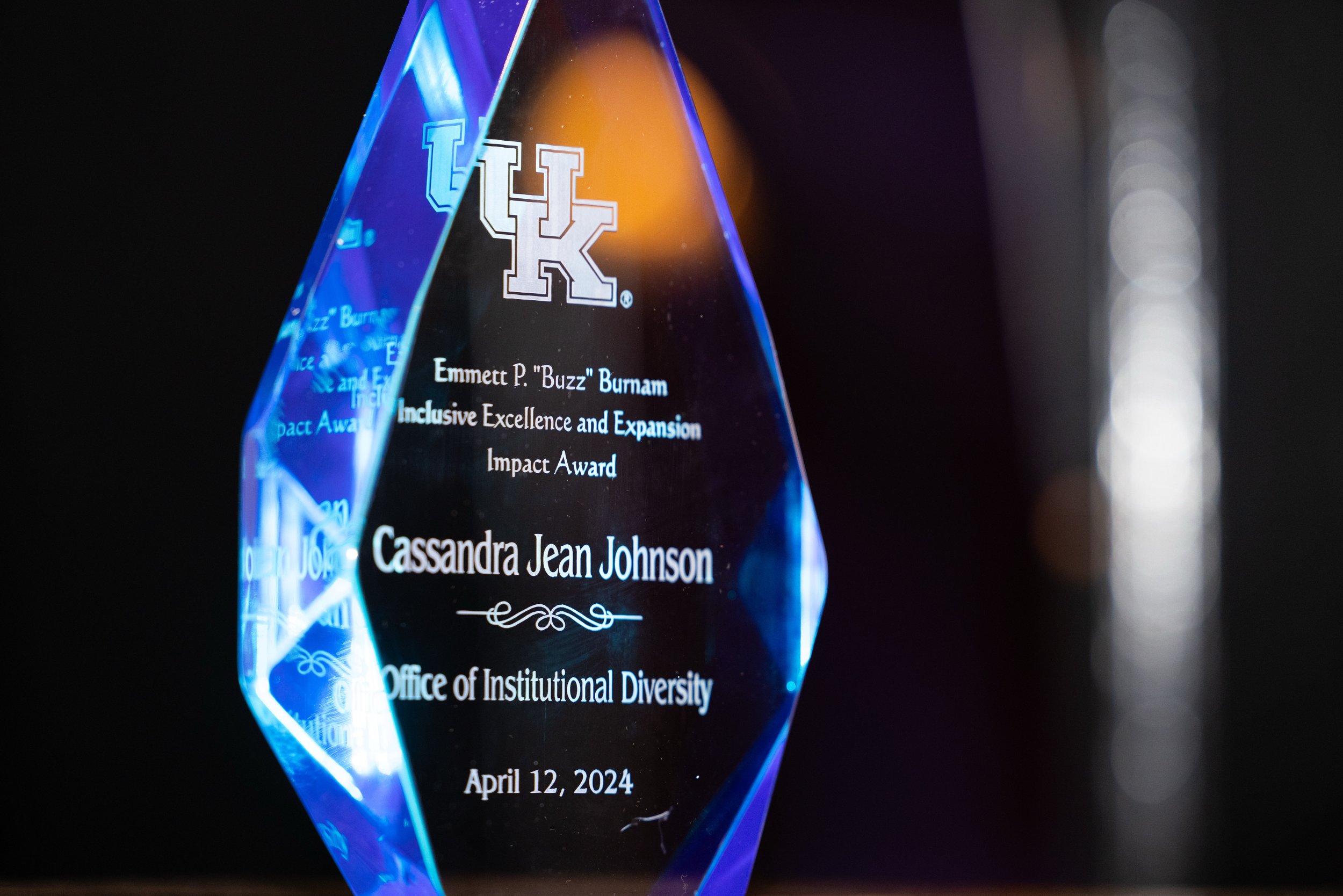 Close-up of the Emmett P. 'Buzz' Burnam Inclusive Excellence and Expansion Impact Award for Cassandra Jean Johnson at a University of Kentucky event, photographed by 859 Photography.