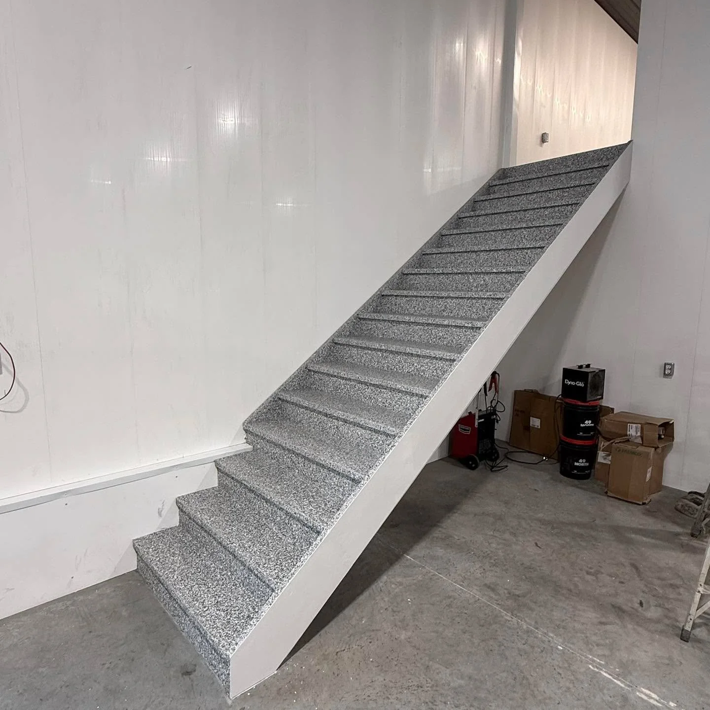 Epoxy over wood? Absolutely. 
Still seamless. Still durable. Still non porous. 
Exactly what this customer wanted for this mezzanine in his machine shop, plus a slip resistant staircase to match.
