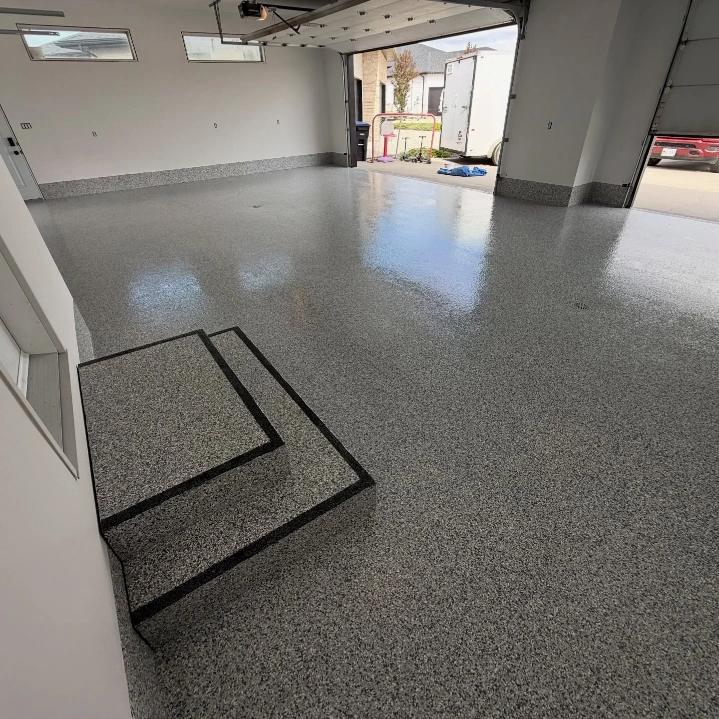 You don&rsquo;t have to settle for a simple, boring garage. 

This transformation from last week included a full flake system in Gravel, wooden landing coated to match and a 1&rsquo; perimeter cove sealed with the floor to protect drywall and framing