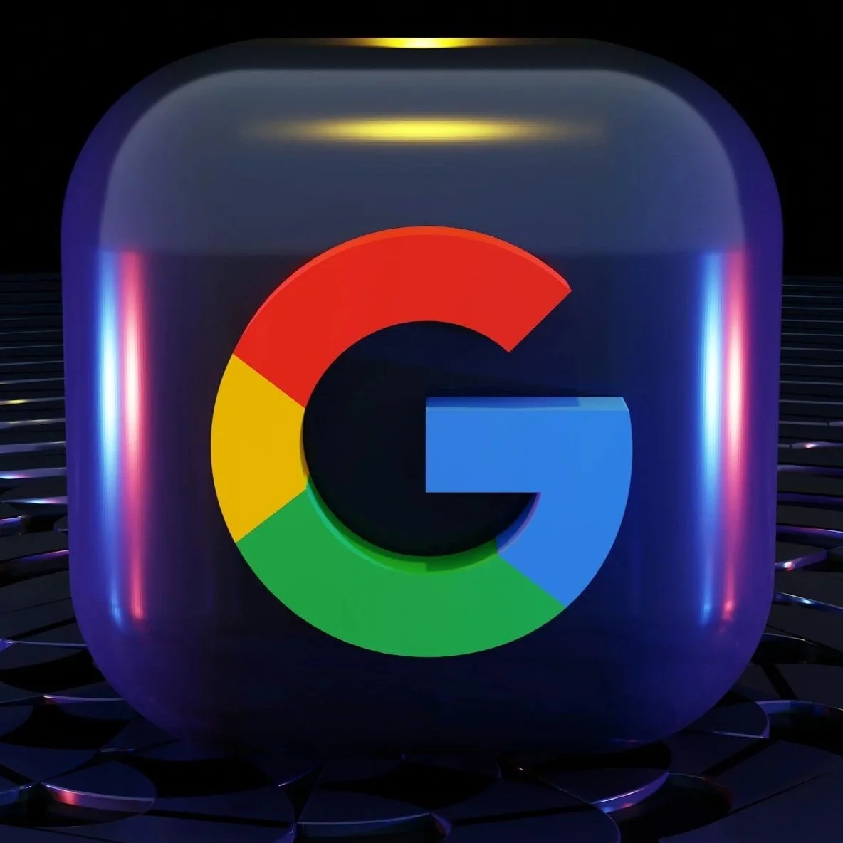A digital rendering of a Google logo inside a rounded cube, illuminated with colorful lights, set against a dark, grid-like background.
