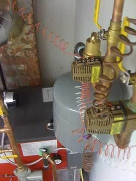 Gas furnace, boiler hydronic system with safety valves and copper pipes service repair and installation in a utility room. by Duran The Plumber LLC