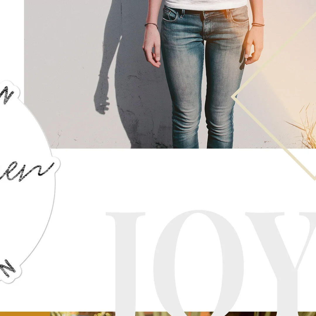 Person wearing blue jeans standing against a white wall with shadows.