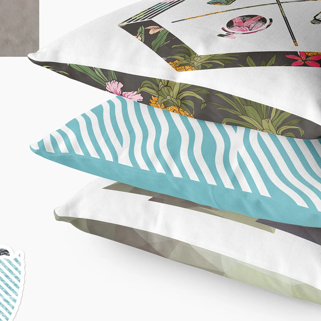 Stacked decorative pillows with floral, striped, and abstract patterns.