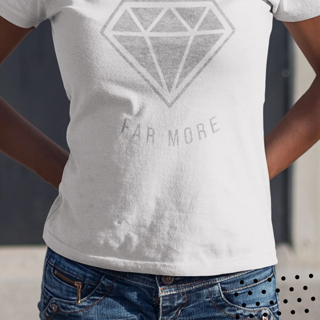 White T-shirt with a large, outlined diamond graphic and the words "FAR MORE" underneath, worn by a person with hands on hips.
