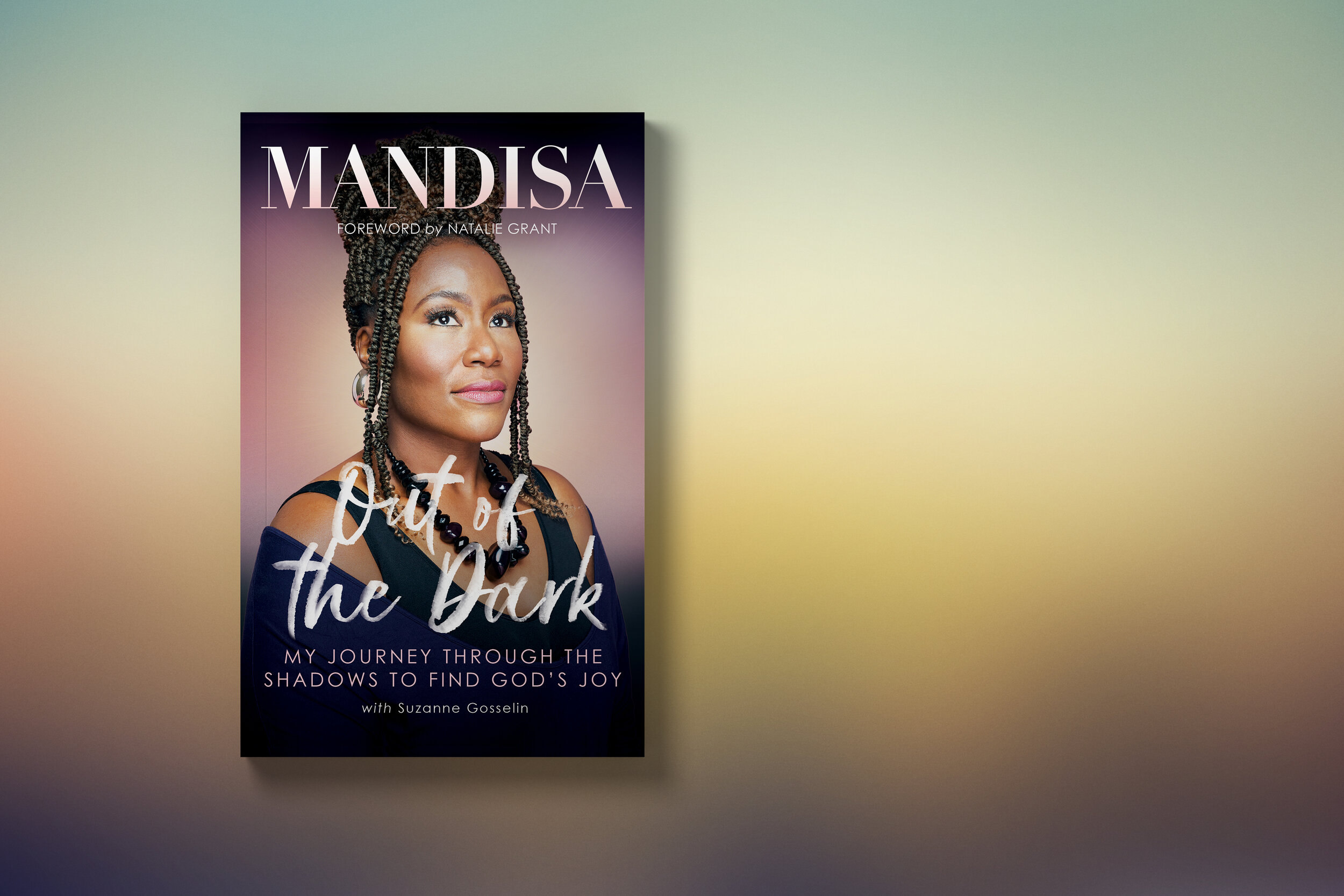 Book cover titled 'Out of the Dark' by Mandisa with a portrait of a woman with braided hair, wearing a black top and statement jewelry, against a gradient background.