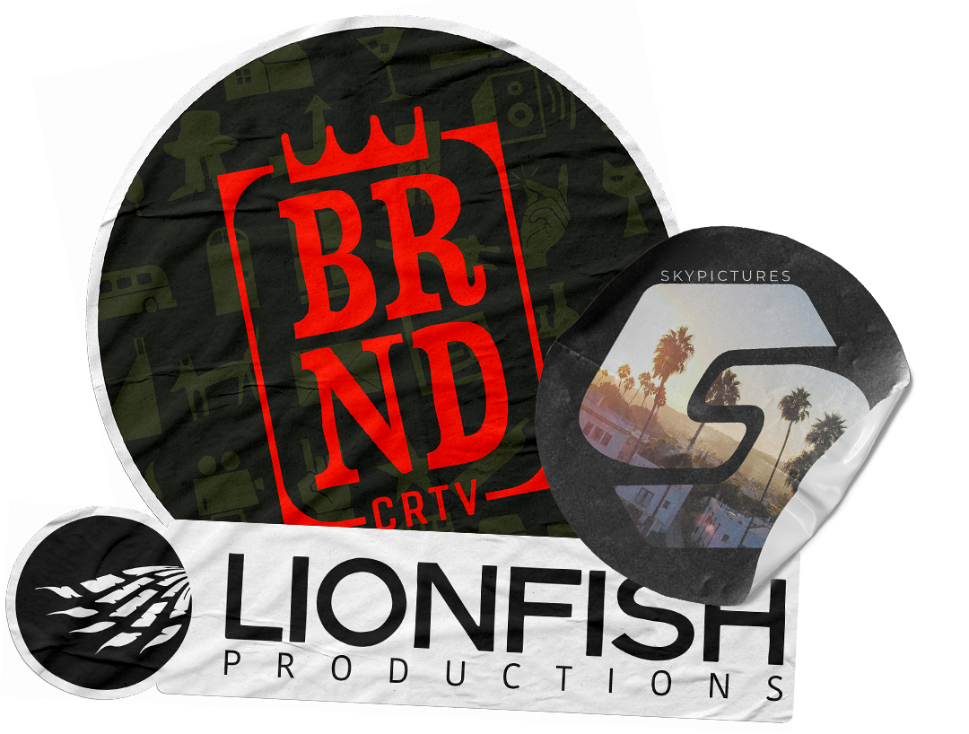 Collection of printed promotional items, including a circular cloth with the brand logo 'BRND CRTV' in red, a rectangular napkin or cloth with 'LIONFISH PRODUCTIONS' logo, and a small wrapped item with a stylized 'S' logo and photo of palm trees and buildings.
