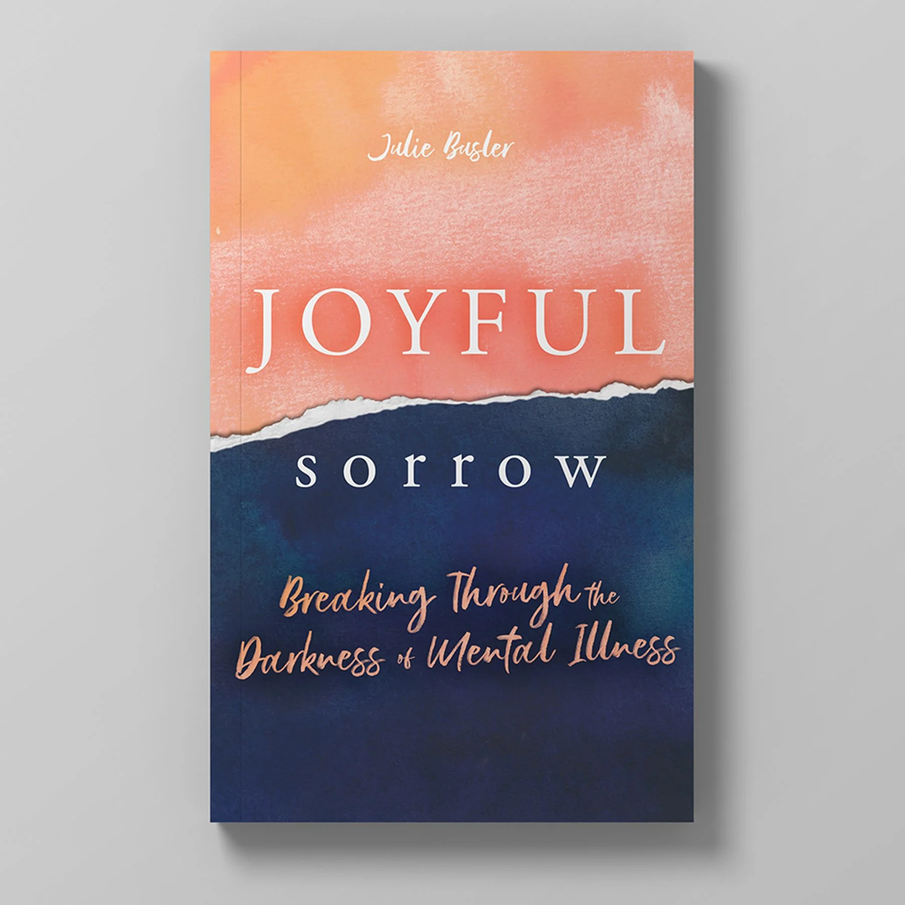 Book cover titled 'Joyful Sorrow: Breaking Through the Darkness of Mental Illness' by Julie Basler, featuring a design with torn paper-style division between peach and navy blue backgrounds.