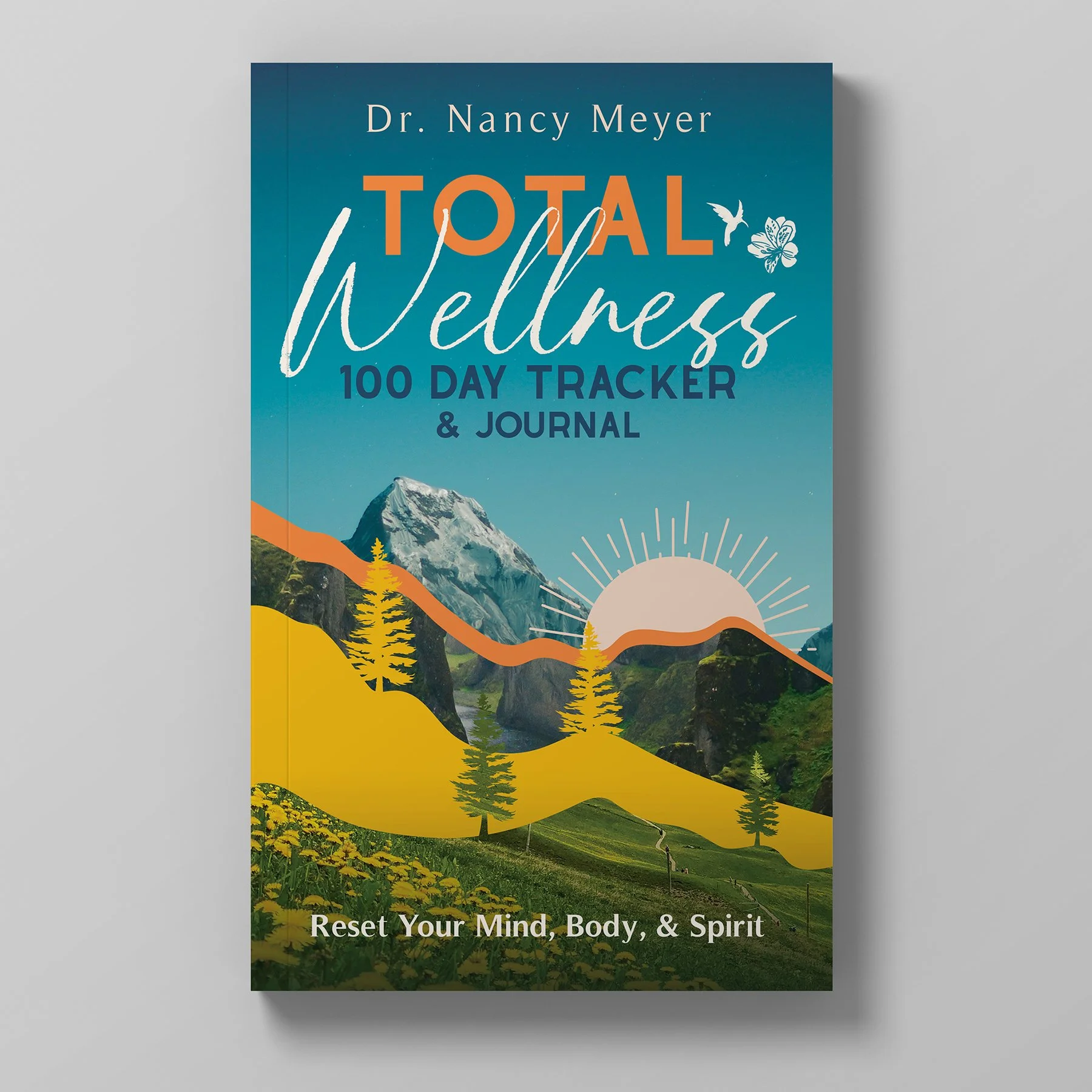 Cover of a wellness journal titled 'Total Wellness 100 Day Tracker & Journal' by Dr. Nancy Meyer, featuring a mountain, sunrise, and nature scene with trees and yellow hills.