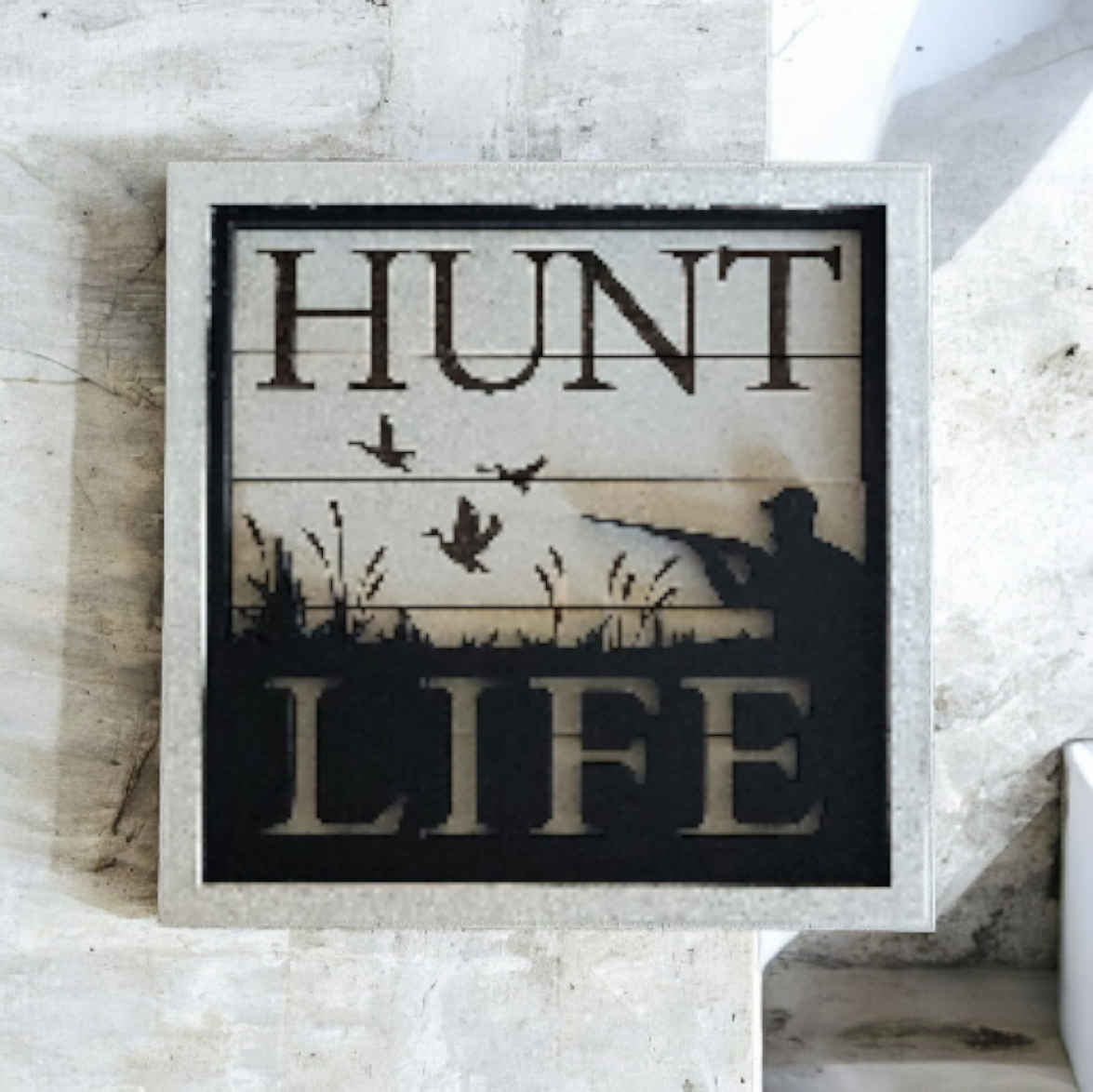Decorative sign with the words 'HUNT LIFE', featuring a silhouette of a duck and flying birds, designed for hunting or outdoor themes.