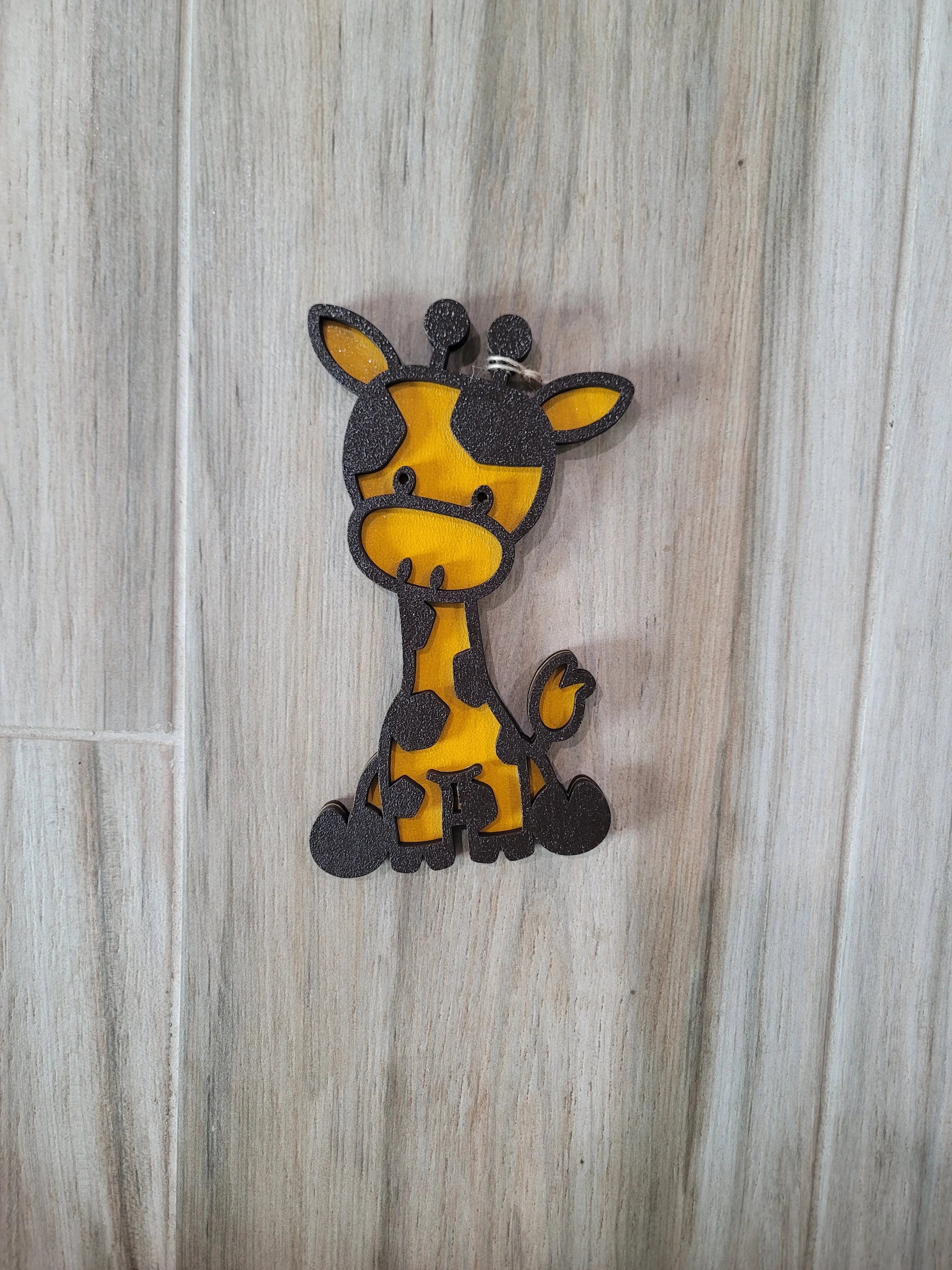 Decorative giraffe with black outlines and yellow 