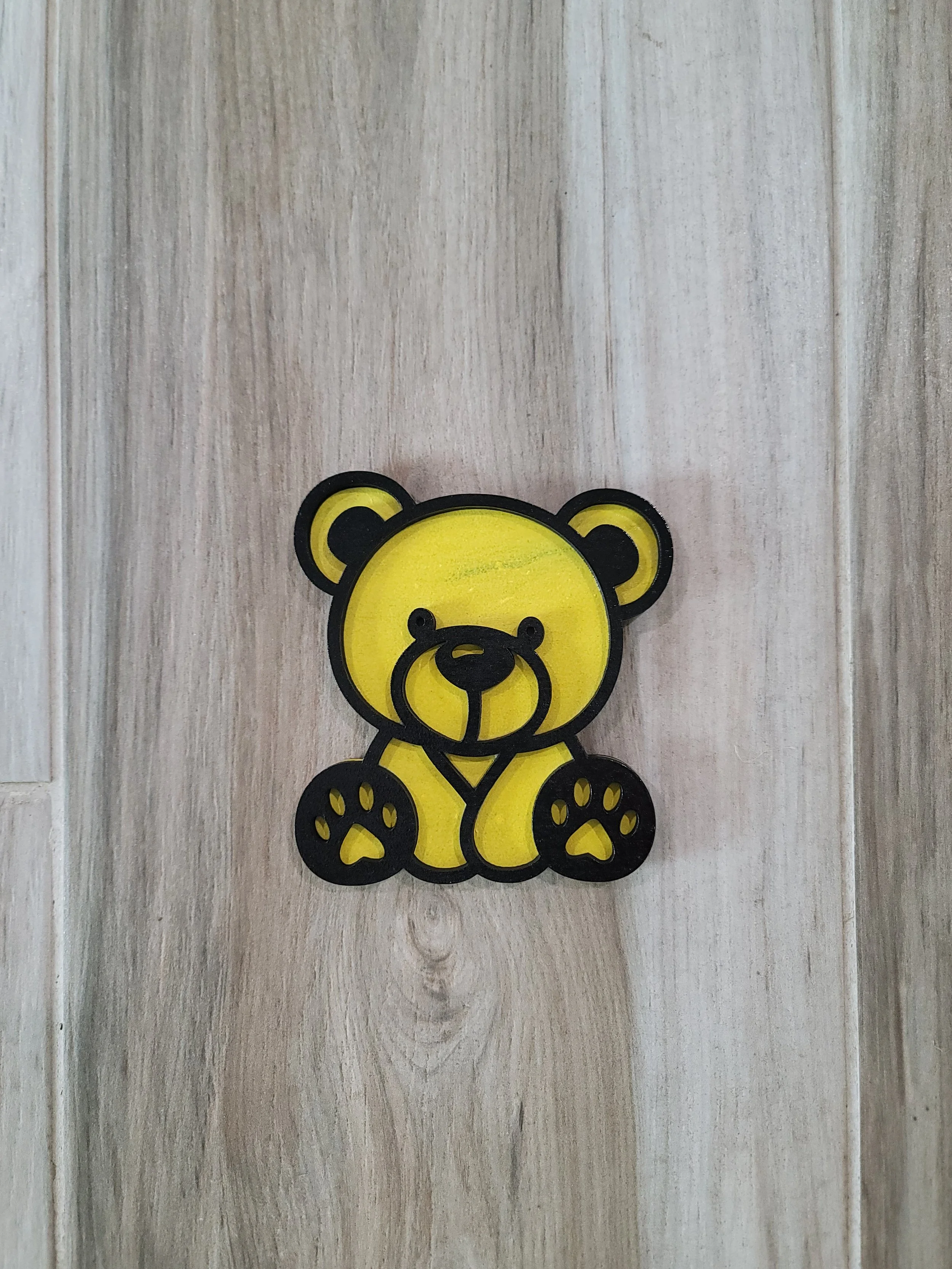 A yellow baby bear with black outlined features