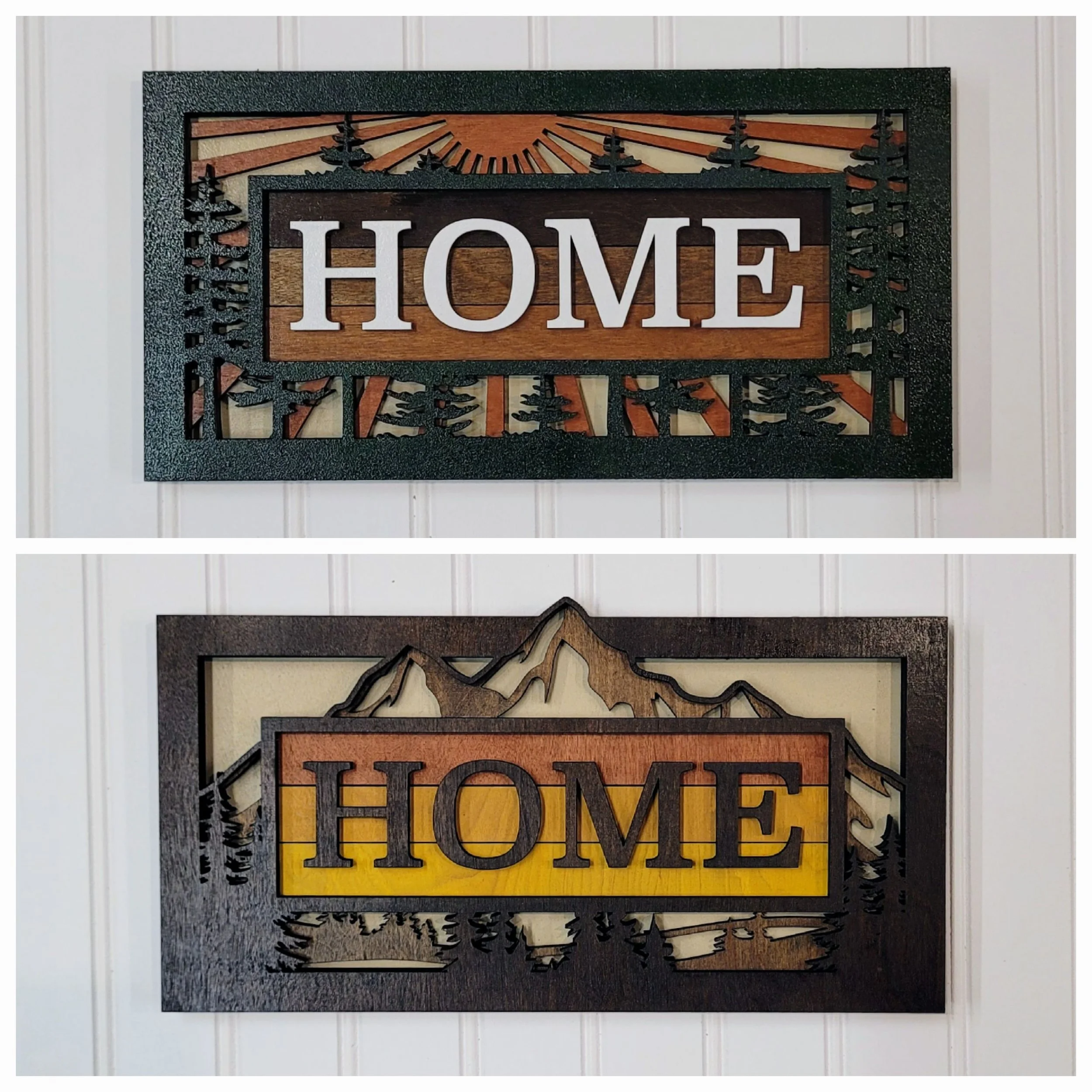 Decorative wall art with the word "HOME" in bold letters, featuring mountain and forest designs in a rustic style.