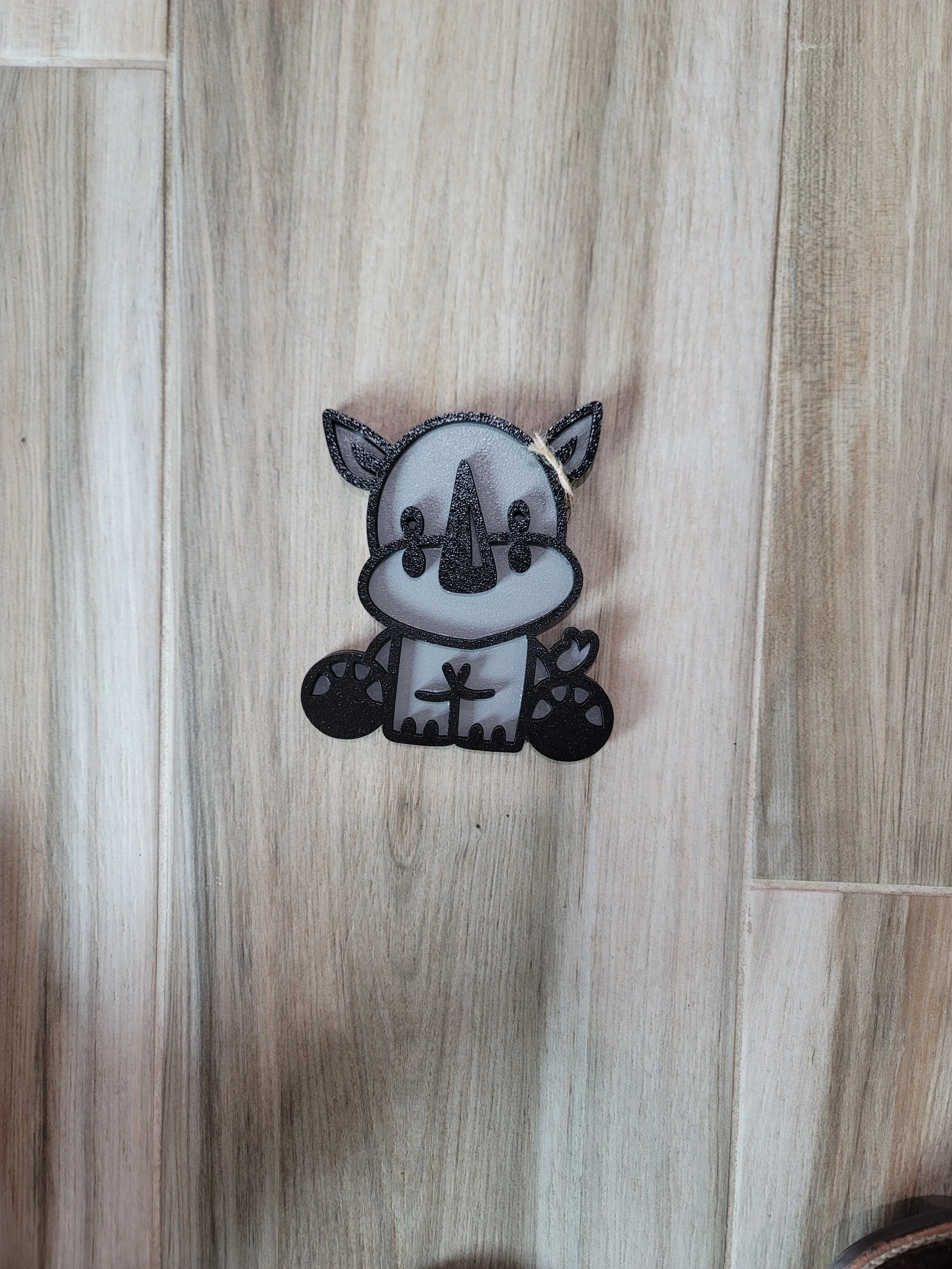 A cartoon-like depiction of a baby rhino