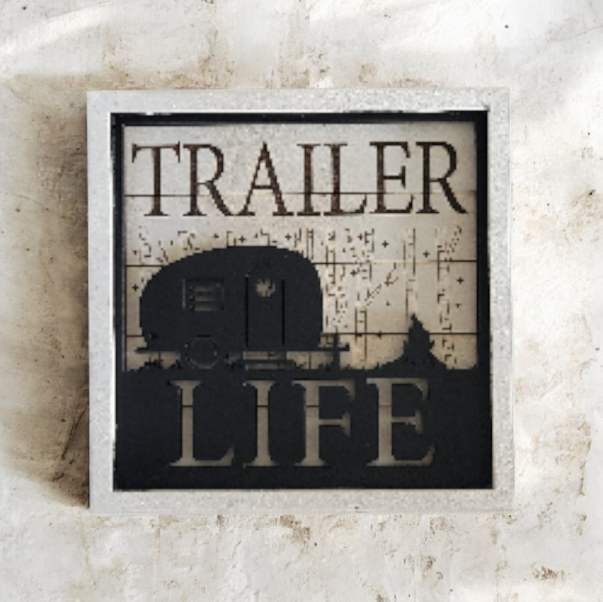 Sign that says "Trailer Life" with a silhouette of a trailer and a landscape background.