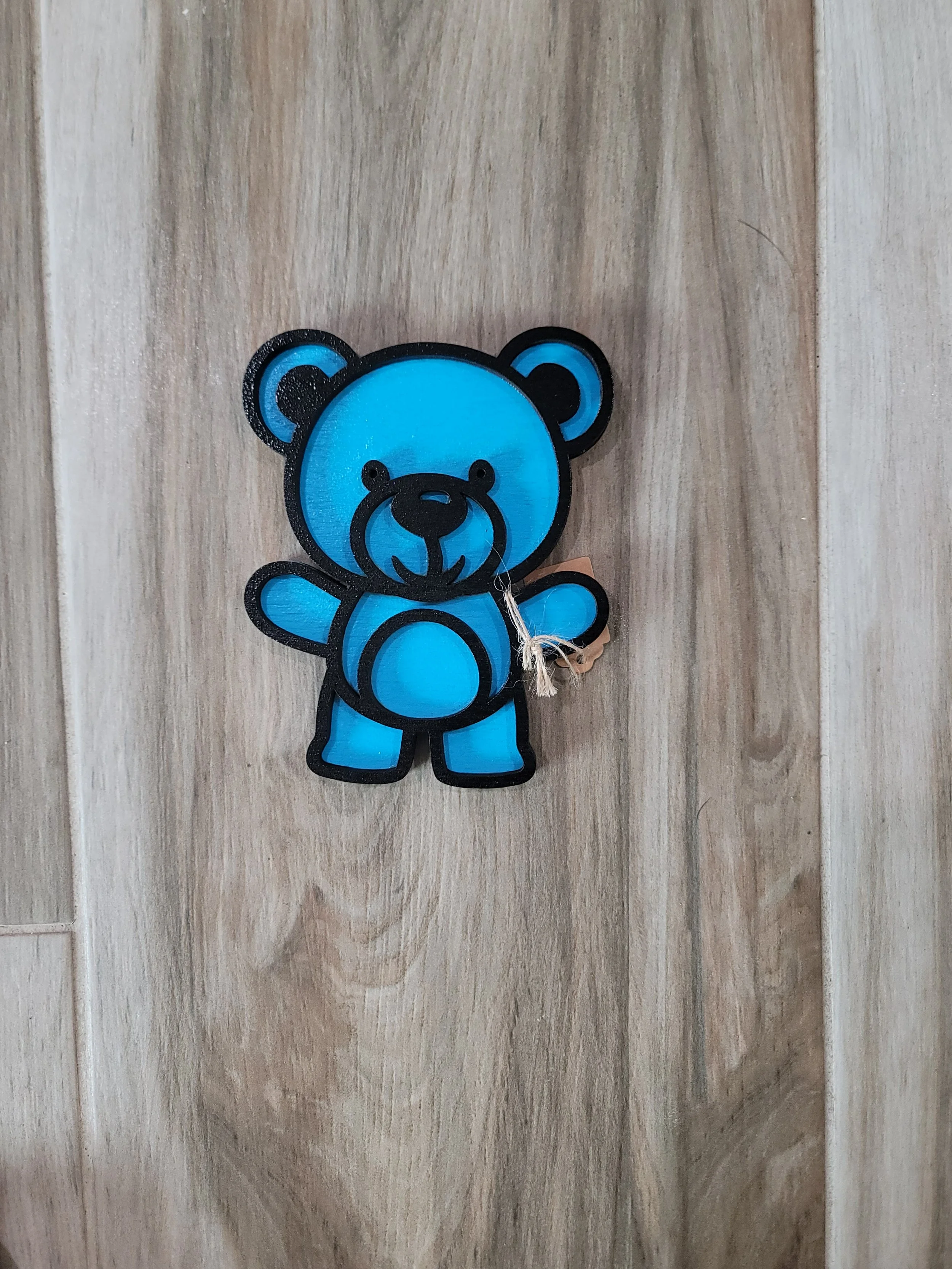 Blue teddy bear on wood