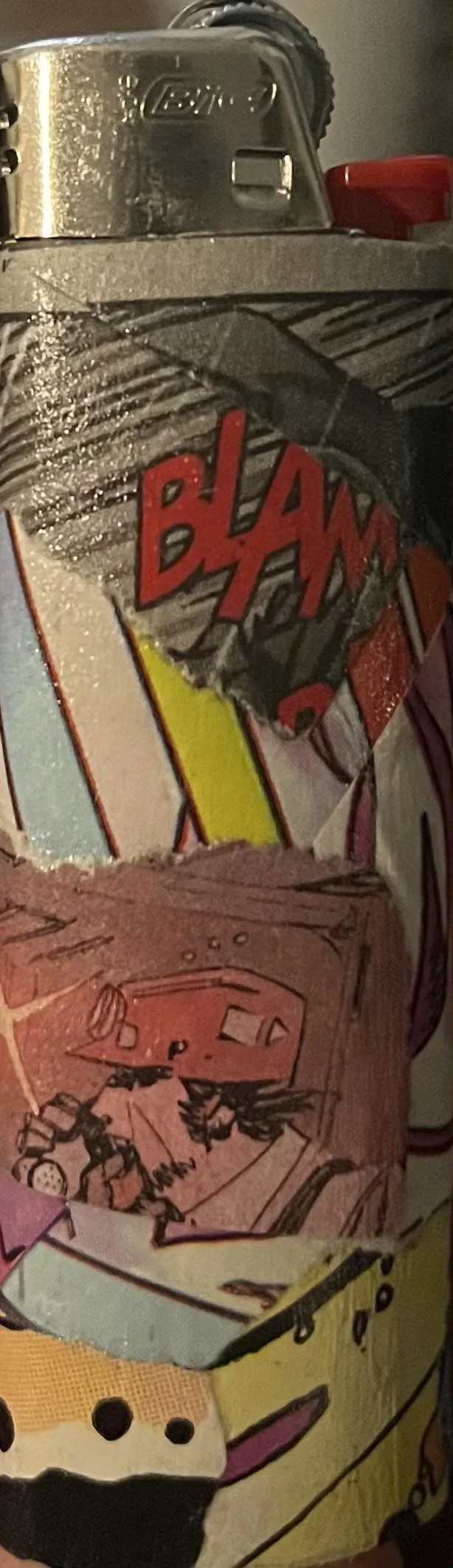 Close-up of a soda can with a comic book style label featuring the word 'BLA' and a scene with cartoon characters, partially obscured.